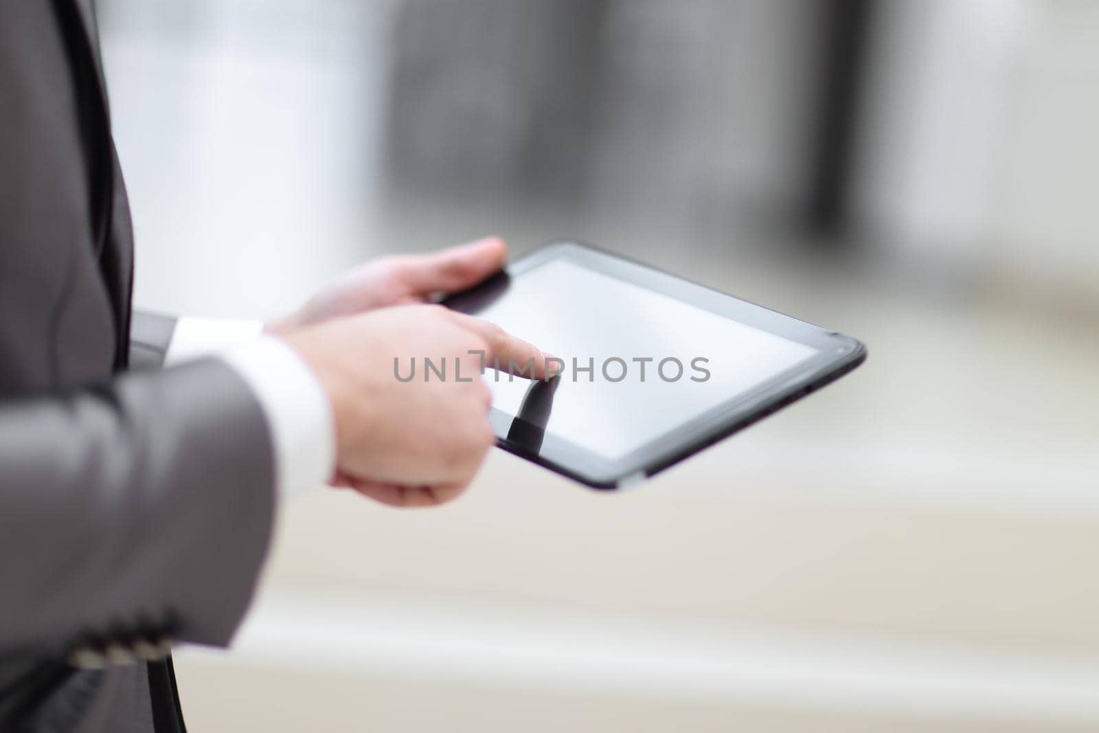 Close-up Of Businessperson Using Digital Tablet With Blank Disp by SmartPhotoLab