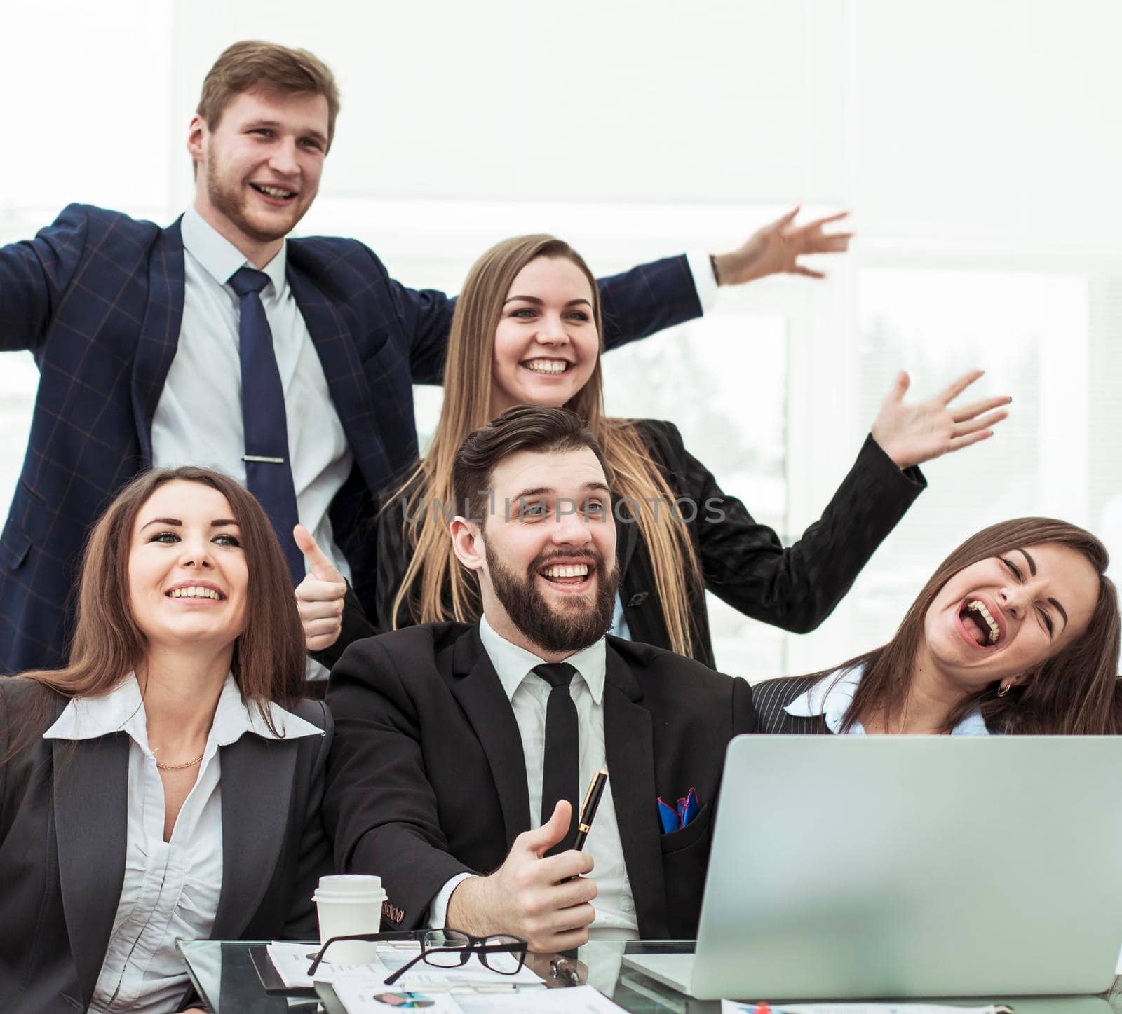 closeup of triumphant business team near the desktop, on the background of the office