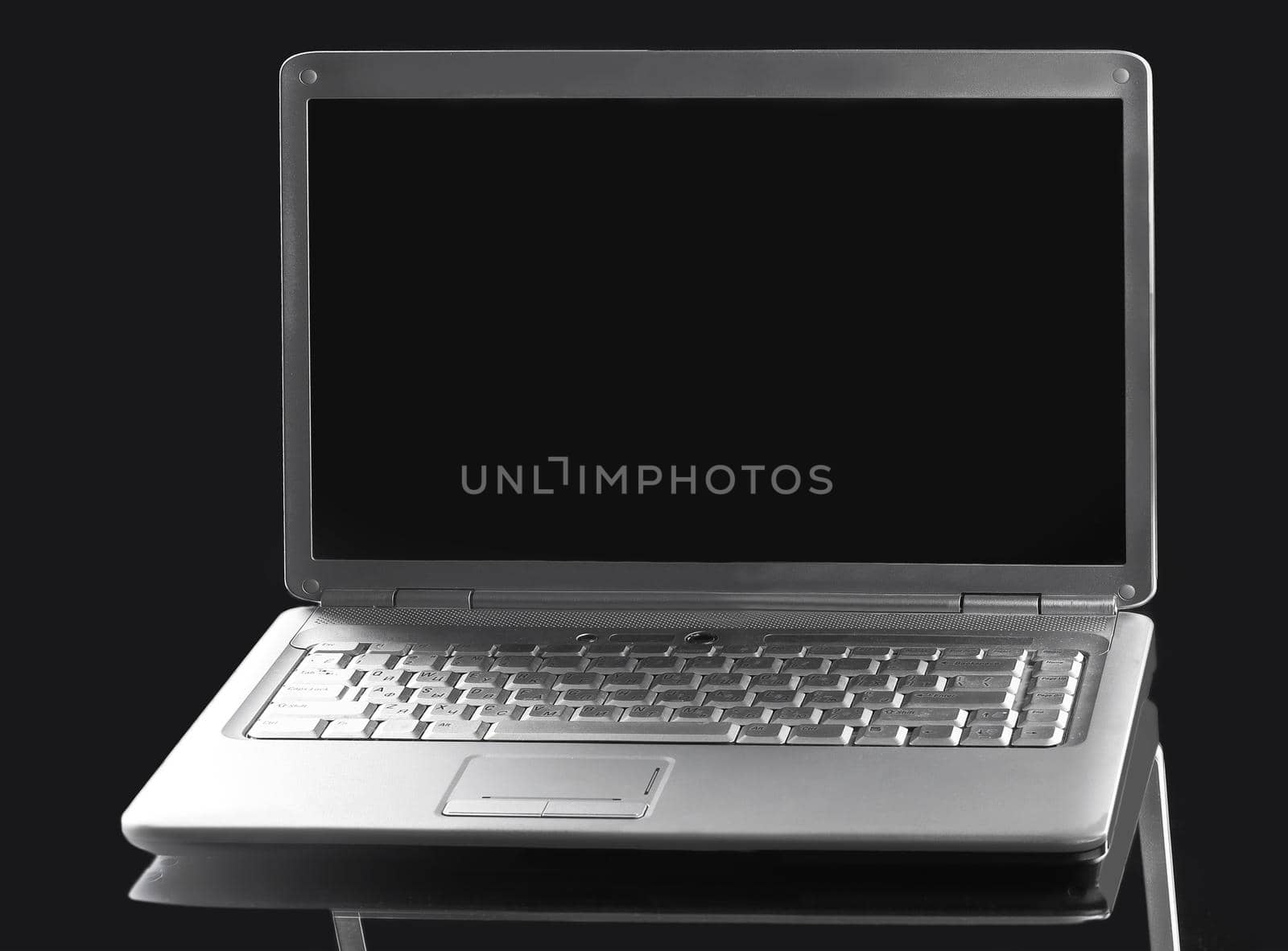 close up. open laptop with blank screen on a dark background by SmartPhotoLab