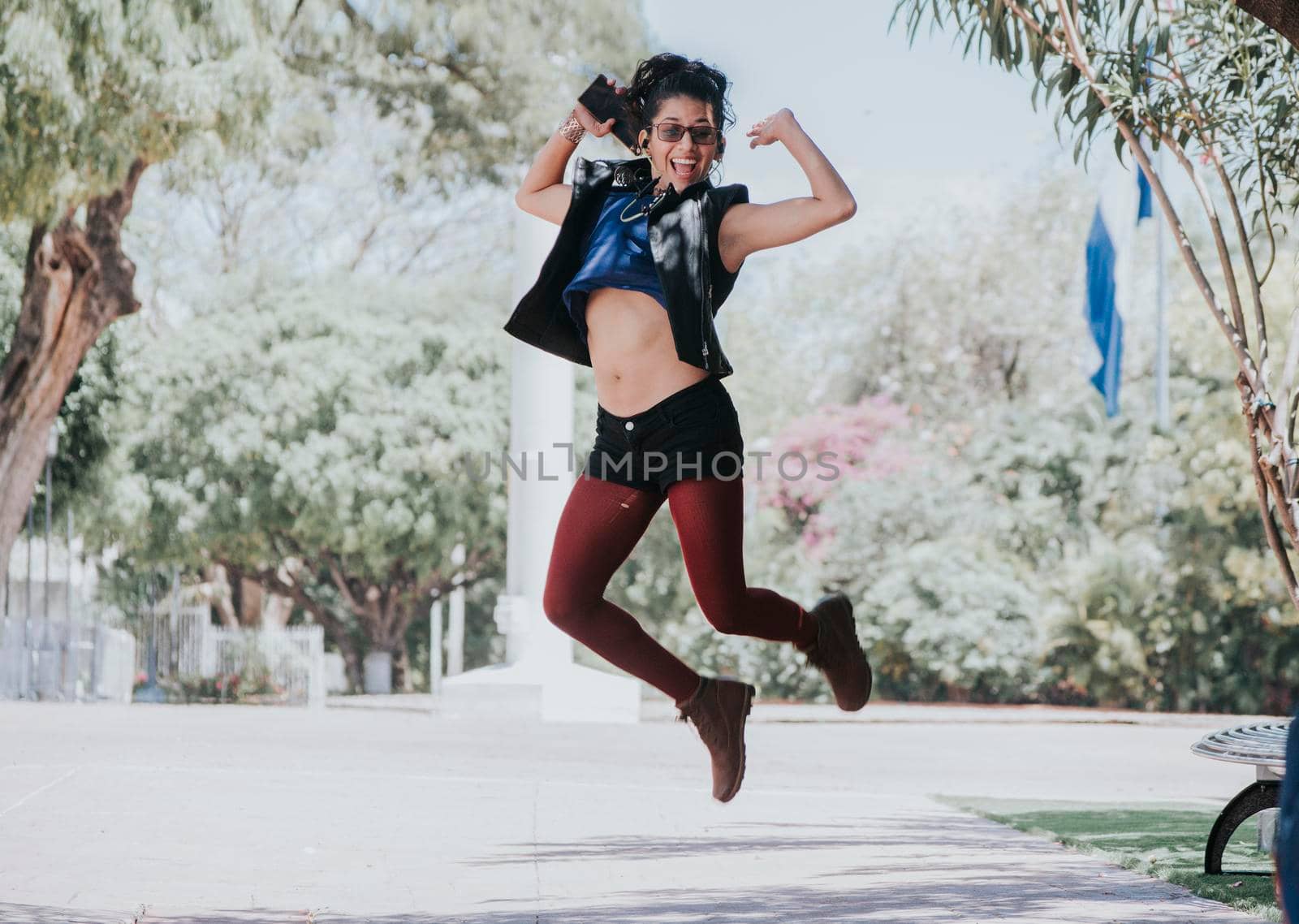 Happy urban girl jumping and listening to music, Girl jumping in the street and listening to music, Lifestyle girl listening to music, Woman jumping and enjoying music