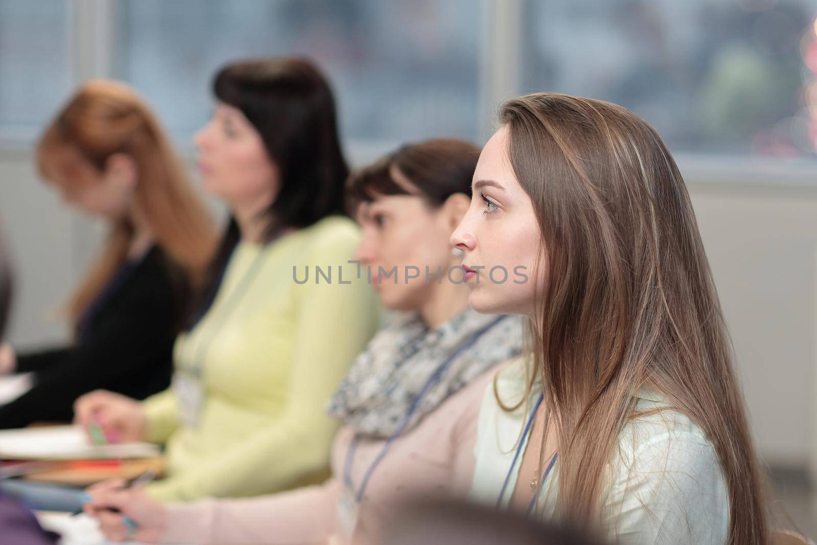 business woman on blurred background of colleagues in the conference room.