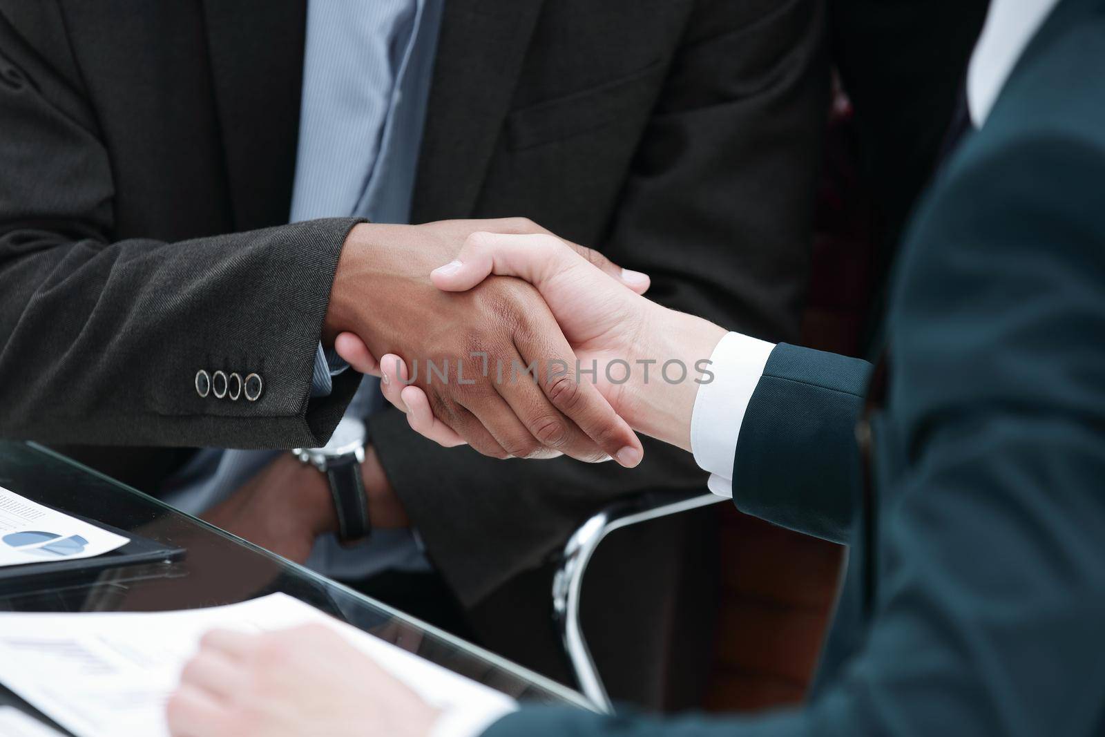 closeup.handshake trading partners on the background of the workplace by SmartPhotoLab