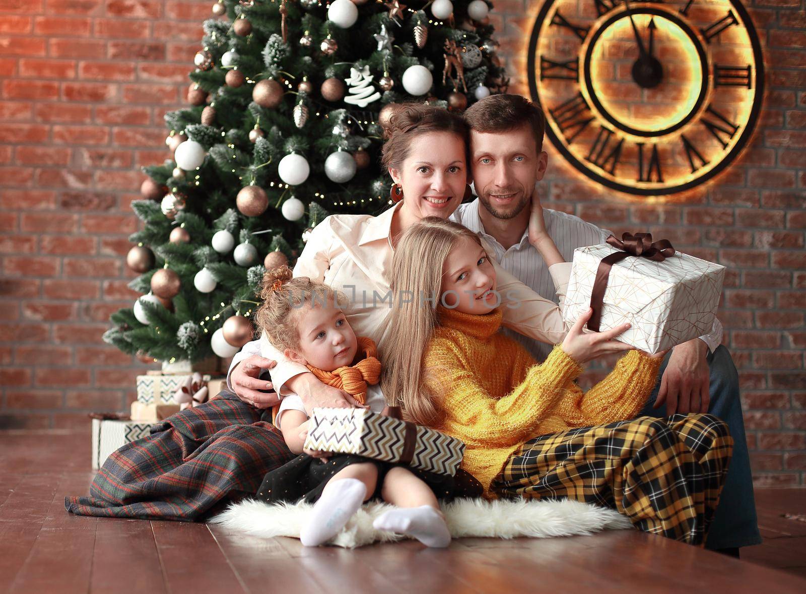 family with Christmas gifts in a cozy living room. photo with copy space .