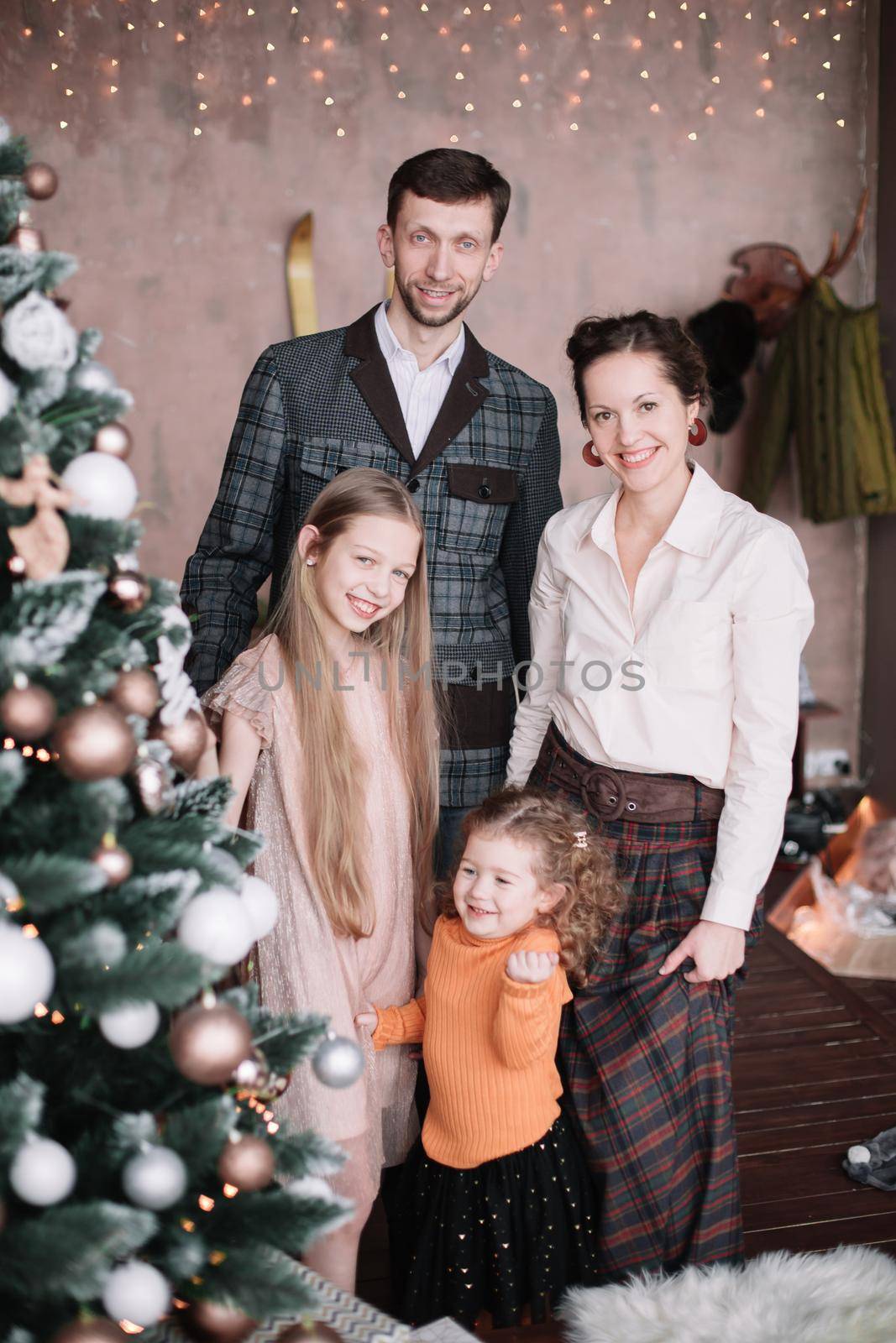 family photo near the elegant Christmas tree . holiday concept
