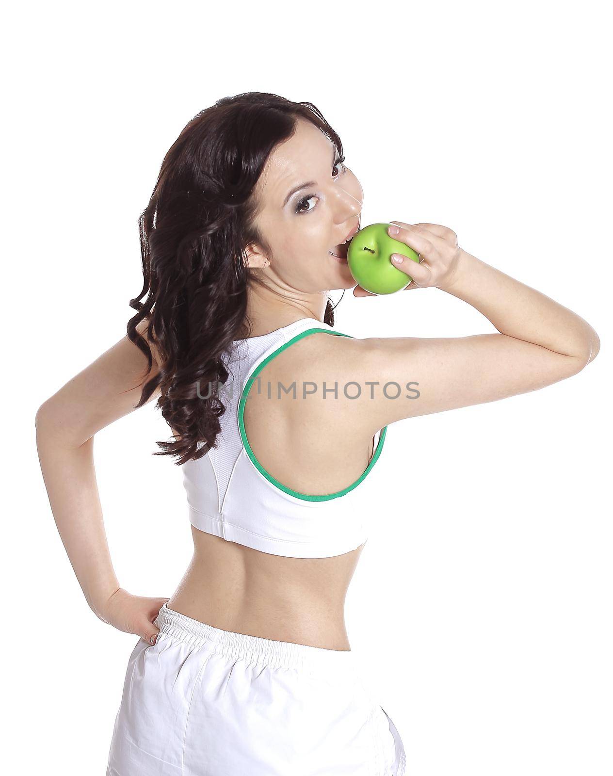 Fitness woman giving you an green apple and smiling on white isolated by SmartPhotoLab