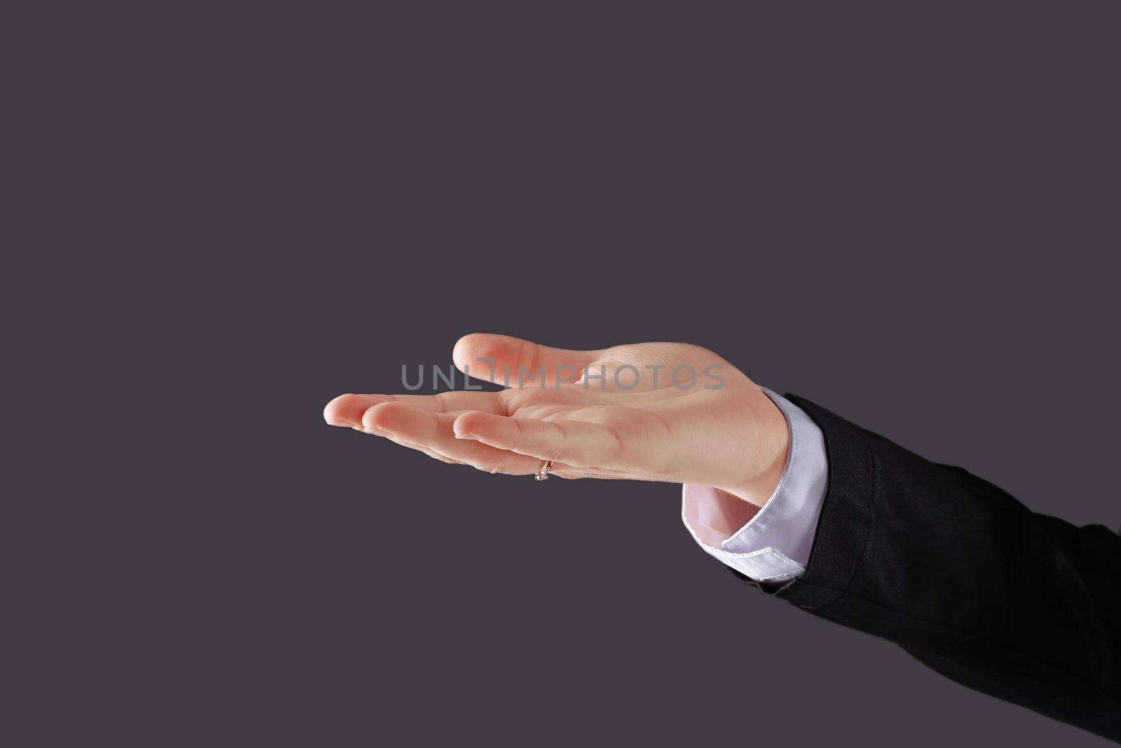 close up. business woman showing open palm .isolated on black background by SmartPhotoLab