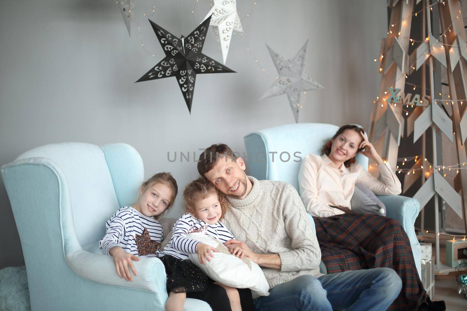 happy family sitting in the living room Christmas evening. by SmartPhotoLab