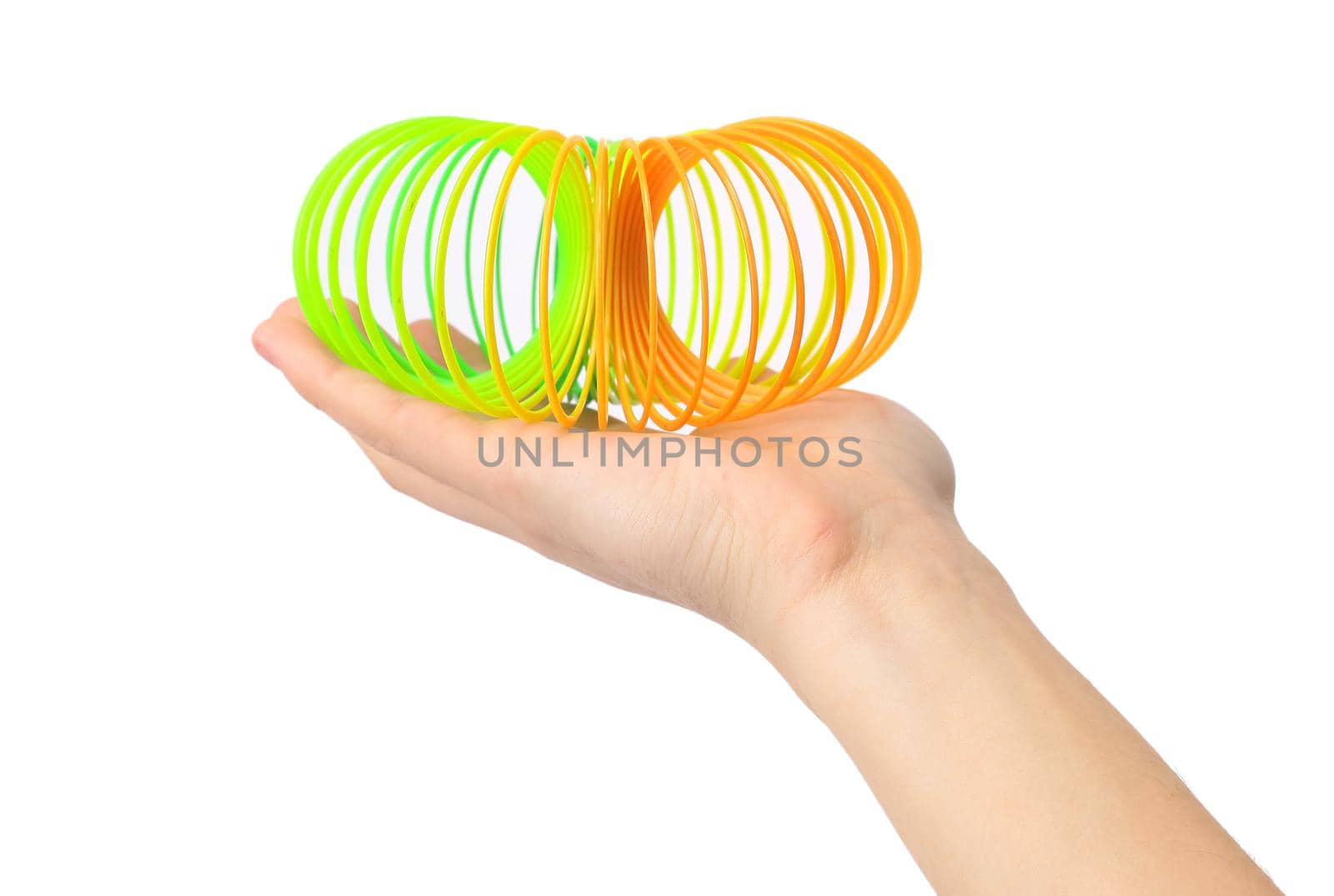 toy spiral in female hand.isolated on white.