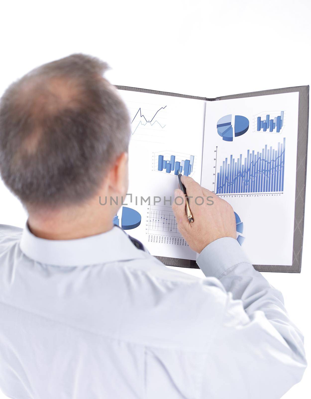 rear view. businessman reading a financial document by SmartPhotoLab