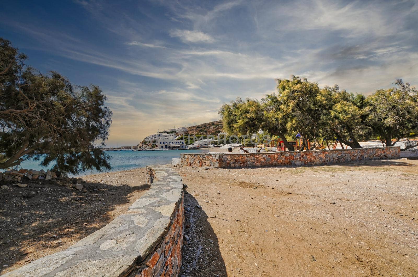 Beautiful beach and view on Sikinos Island with some trees and sand, Cyclades, Greece..