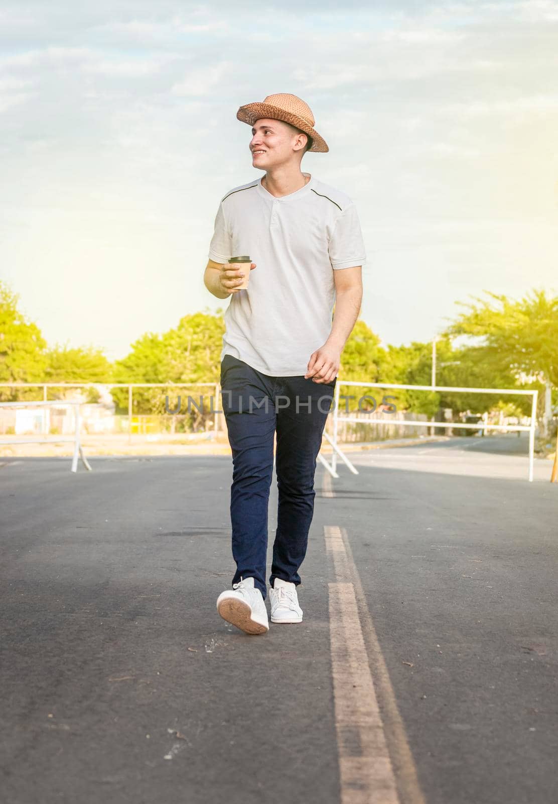 Happy man walking with glass of coffee, happy young man walking with glass of coffee