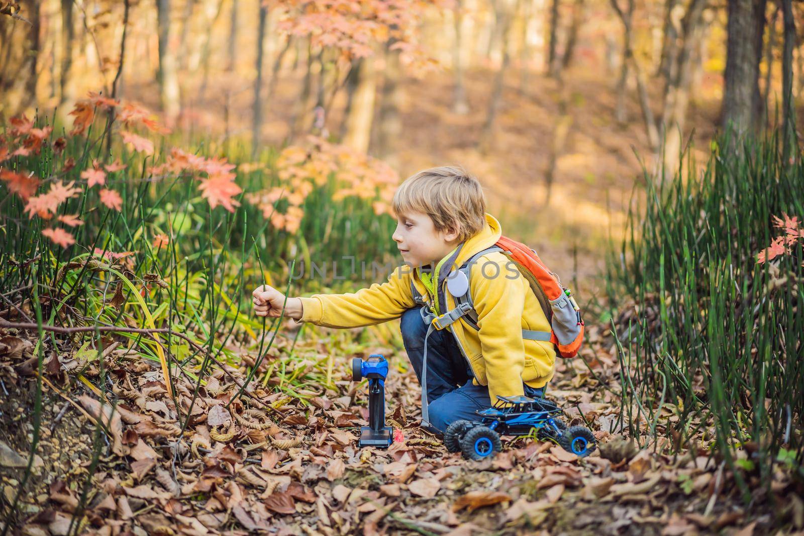 Portrait of little smiling child on head background of sunny autumn park.