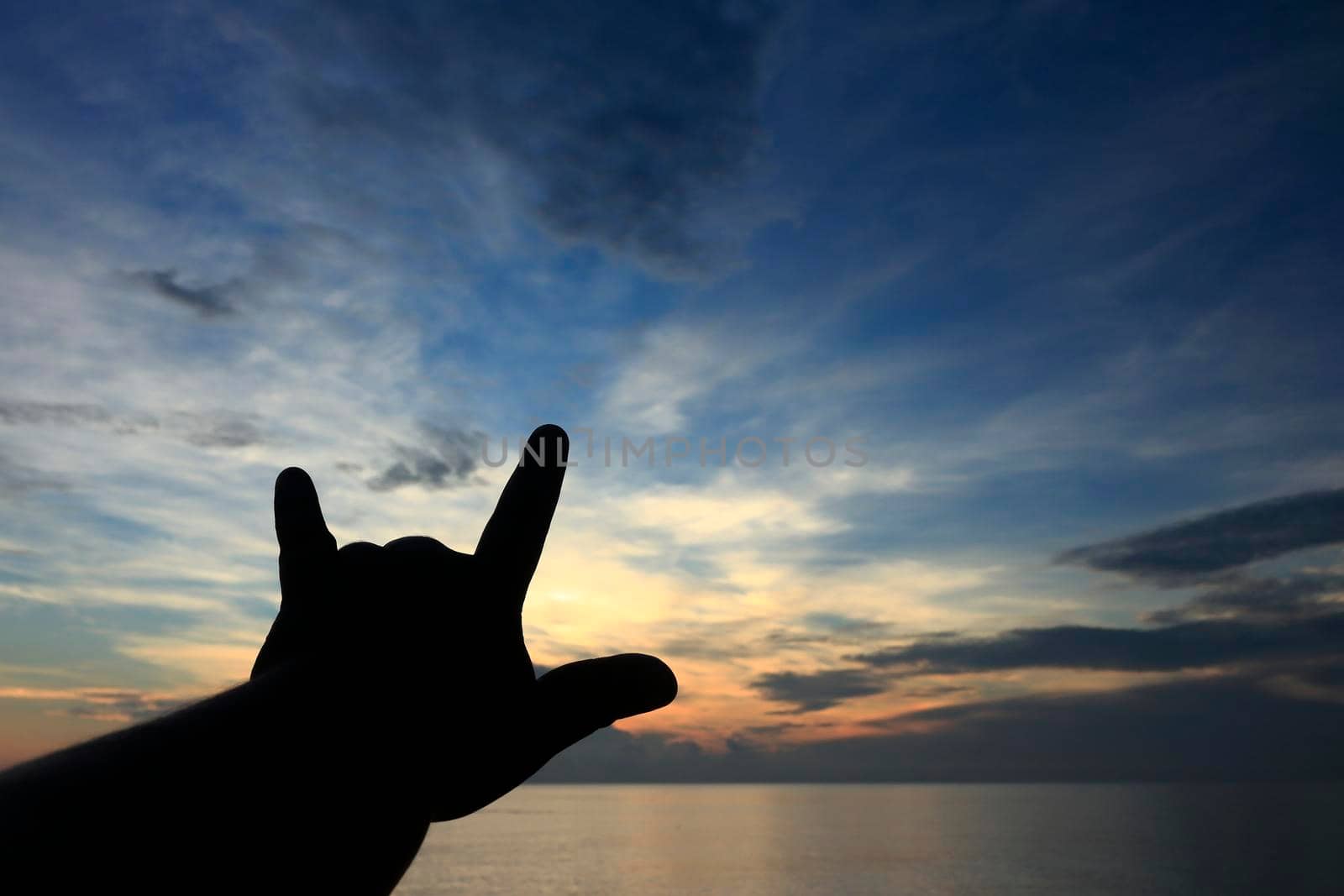 Silhouette raising 3 fingers thumb index finger little finger
It means "I Love You"