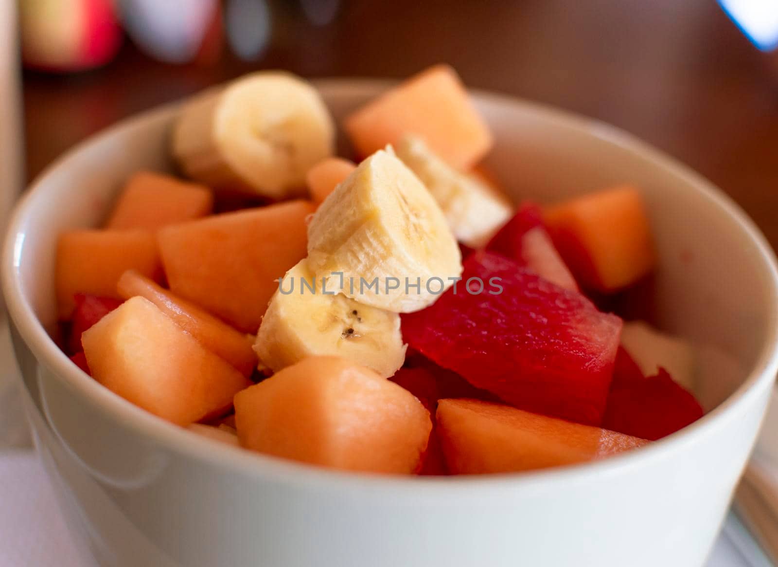 A bowl of fruit salad, close up of banana salad with fruits, healthy fruits concept
