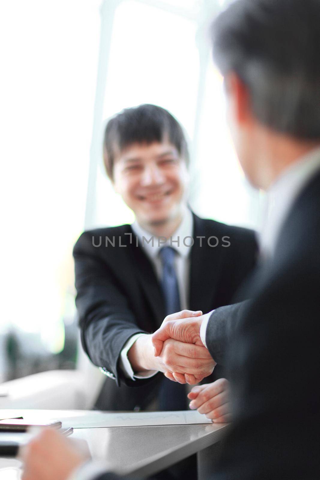 background image close-up of handshake of business partners by SmartPhotoLab