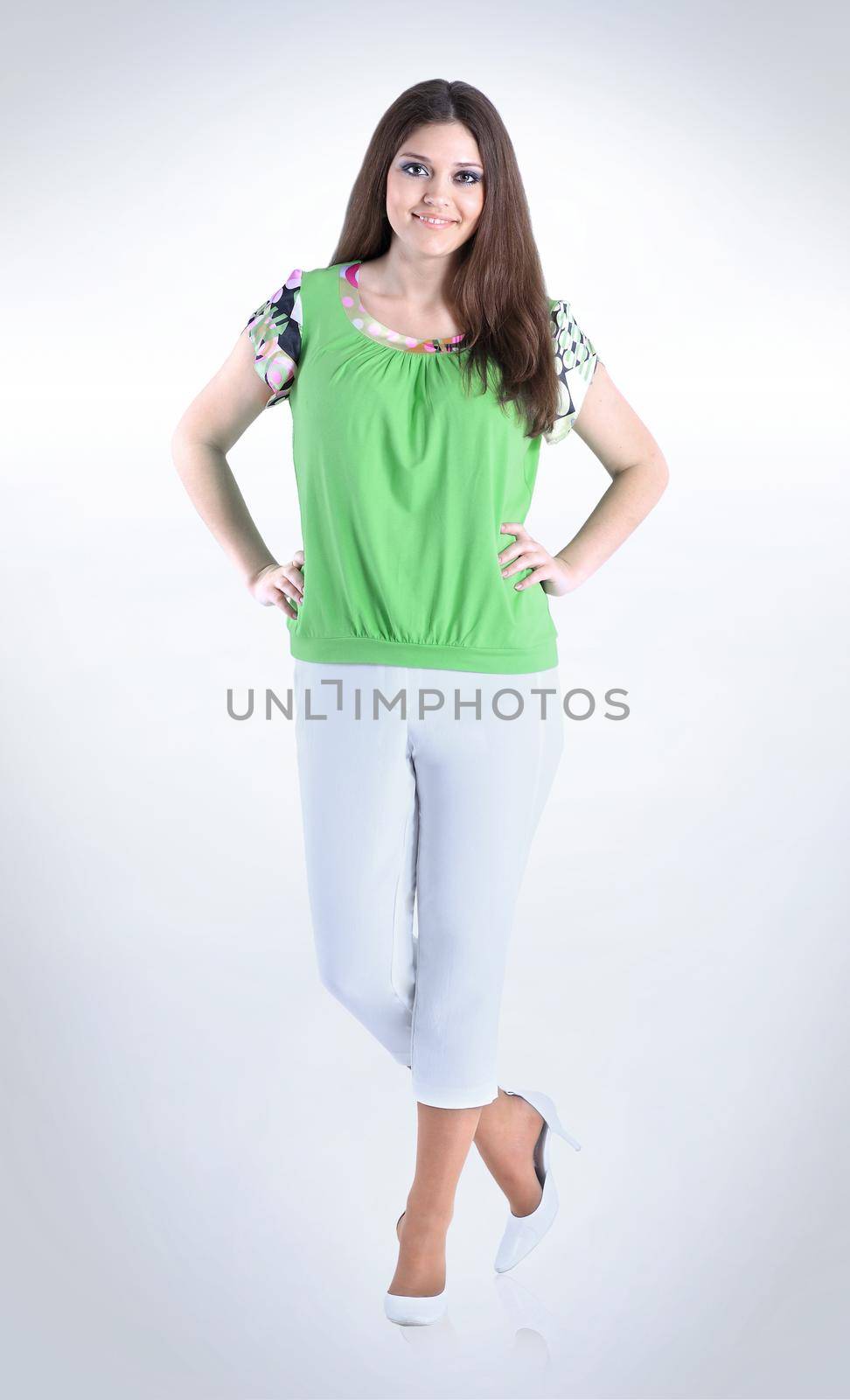in full growth.portrait of a young woman in casual wear .isolated on white.