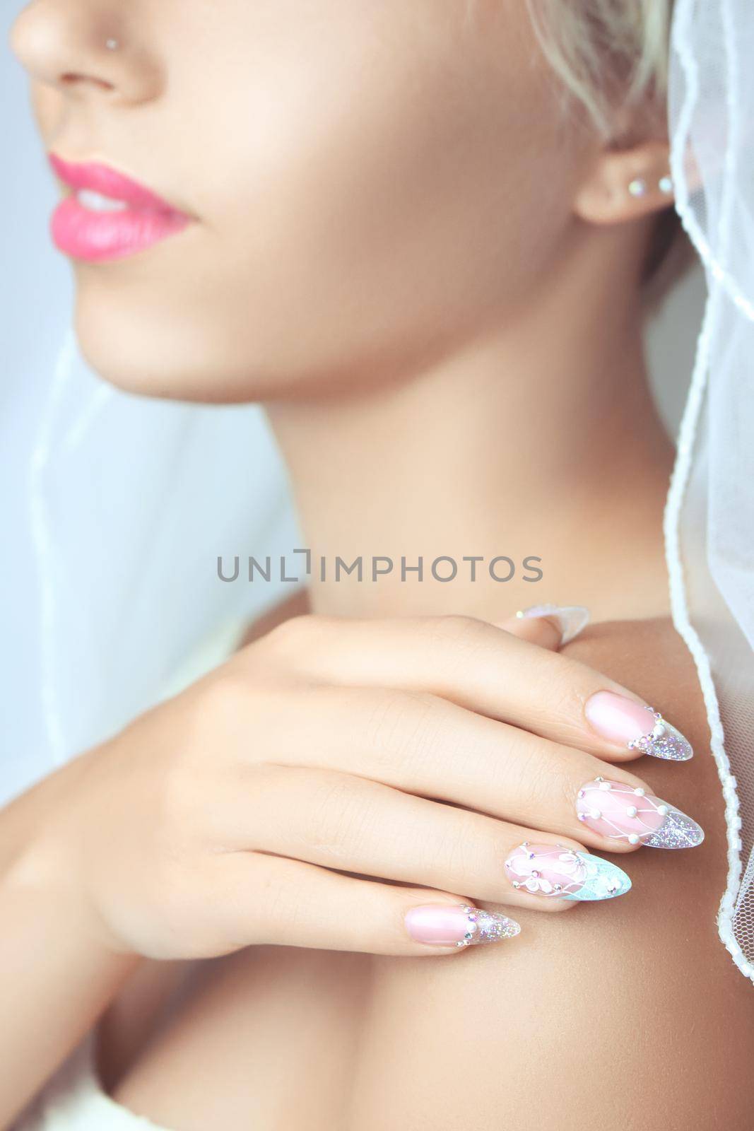 Hands with french manicure on a wedding dress. by Taut