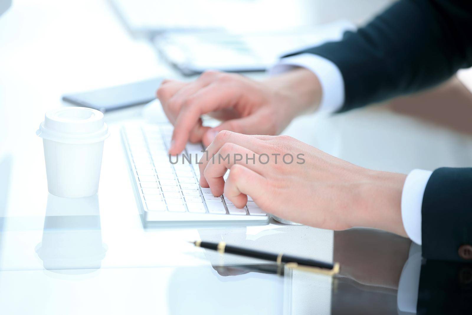 close up .businessman typing on computer keyboard. by SmartPhotoLab