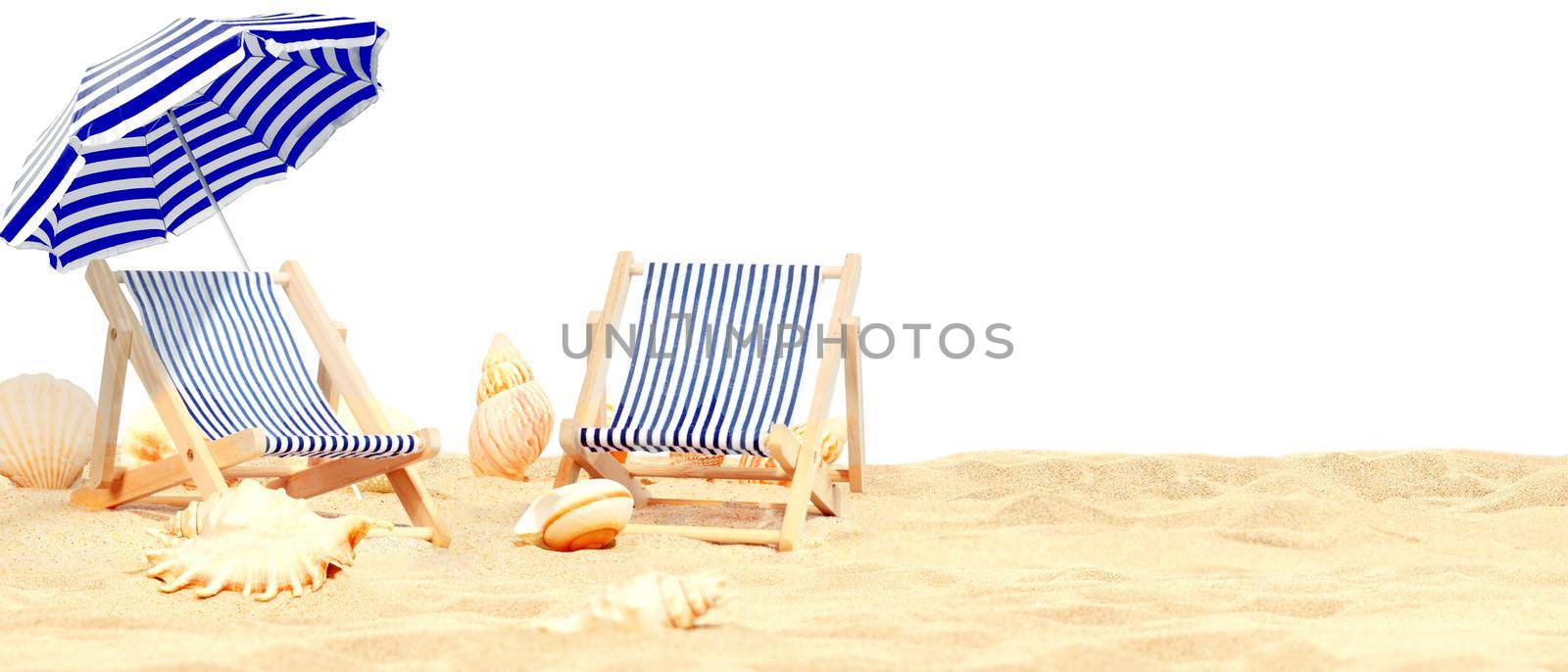 Relax on tropical beach in the sun on deck chairs under umbrella. by Taut