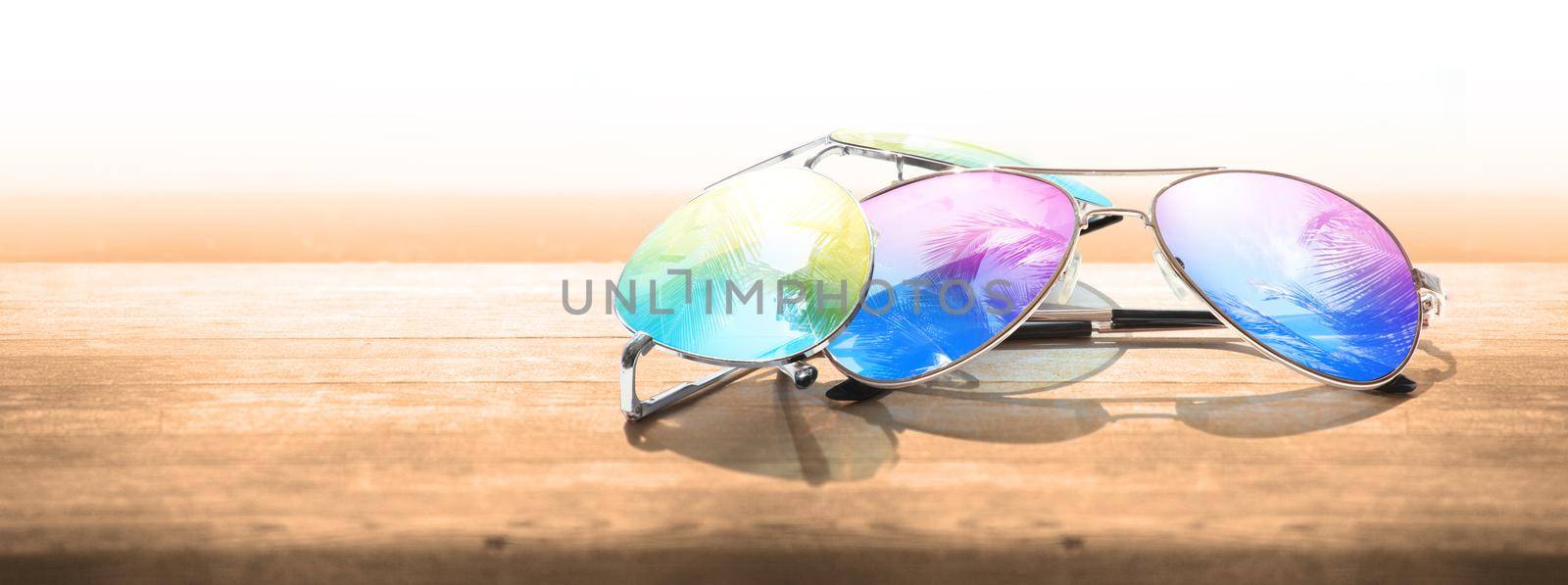 Summer vacation concept. Sunglasses with ocean beach and palms.