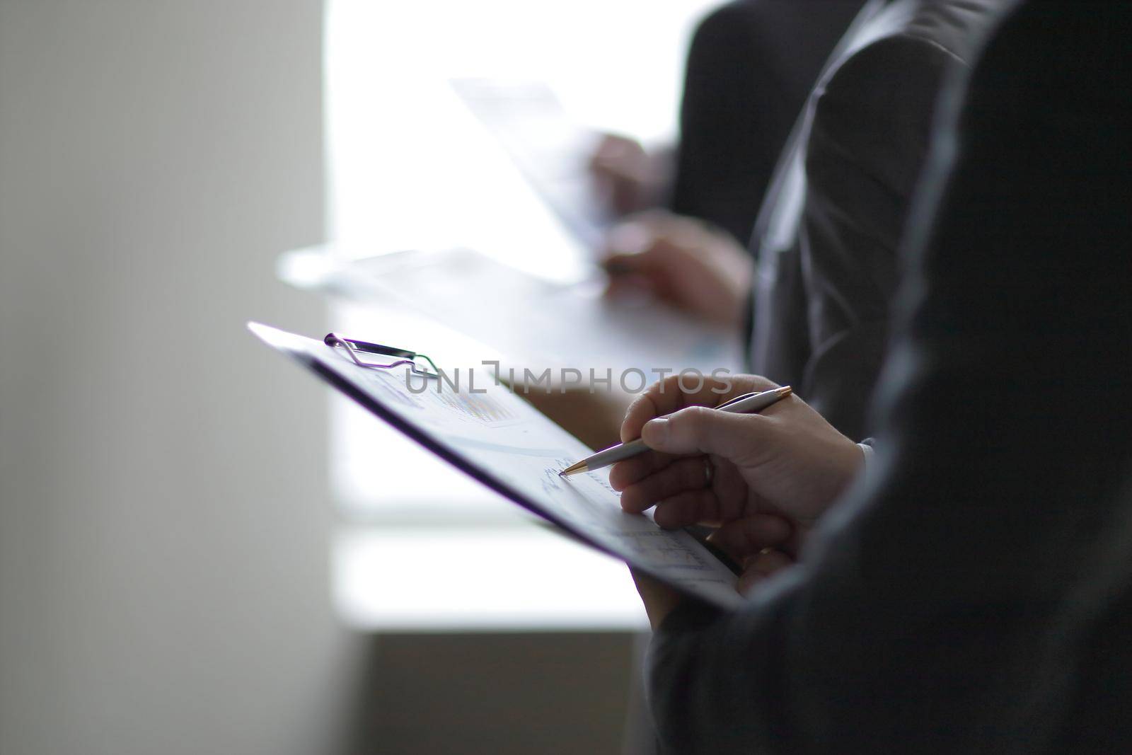 close up.businessman with clipboard checking financial report.