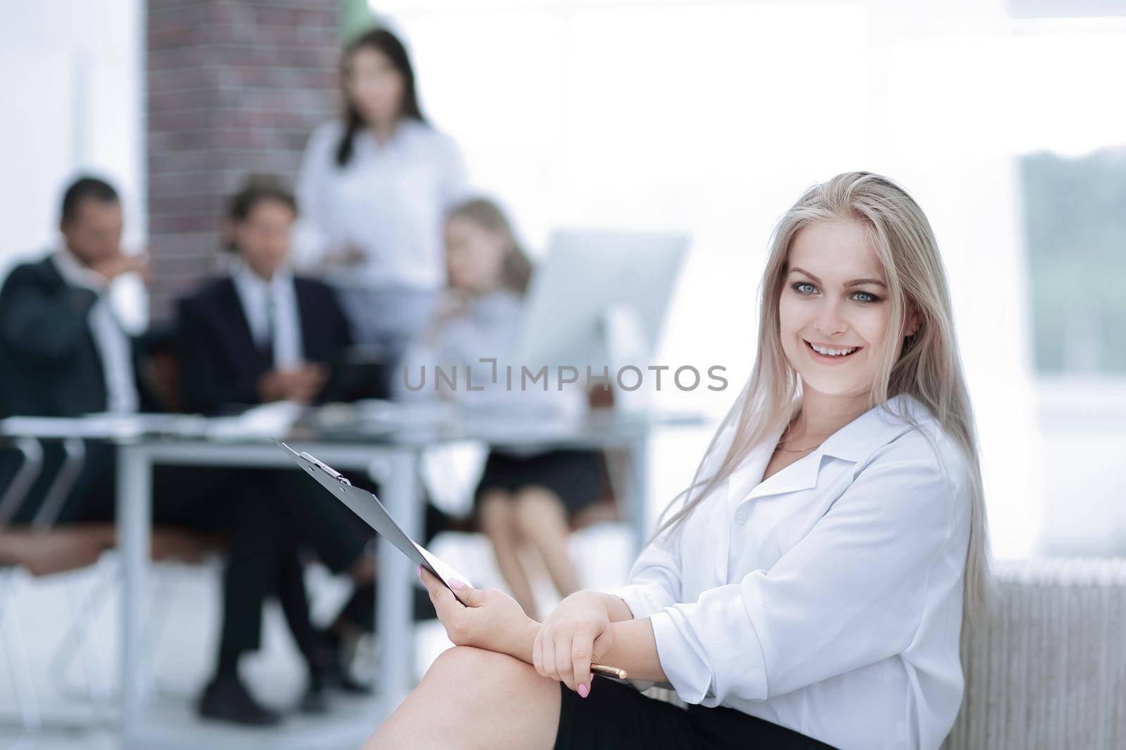 female assistant with the minutes of the meeting on the background of the office.photo with copy space.