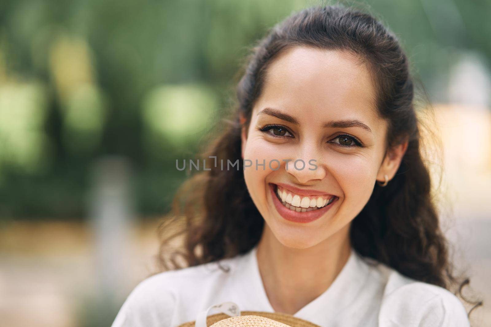 Young beautiful cheerful girl in a summer park. High quality photo