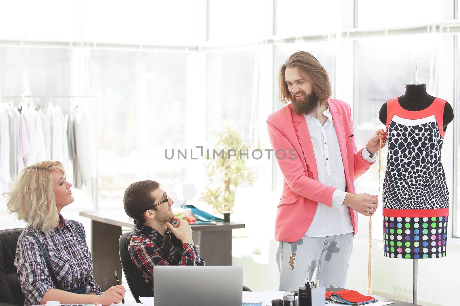 Group of business people brainstorming in a fashion clothing company.