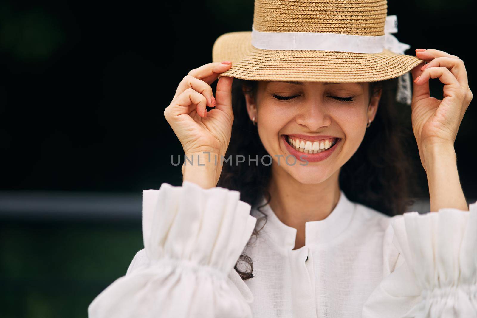 Young beautiful girl in a hat in a summer park. High quality photo