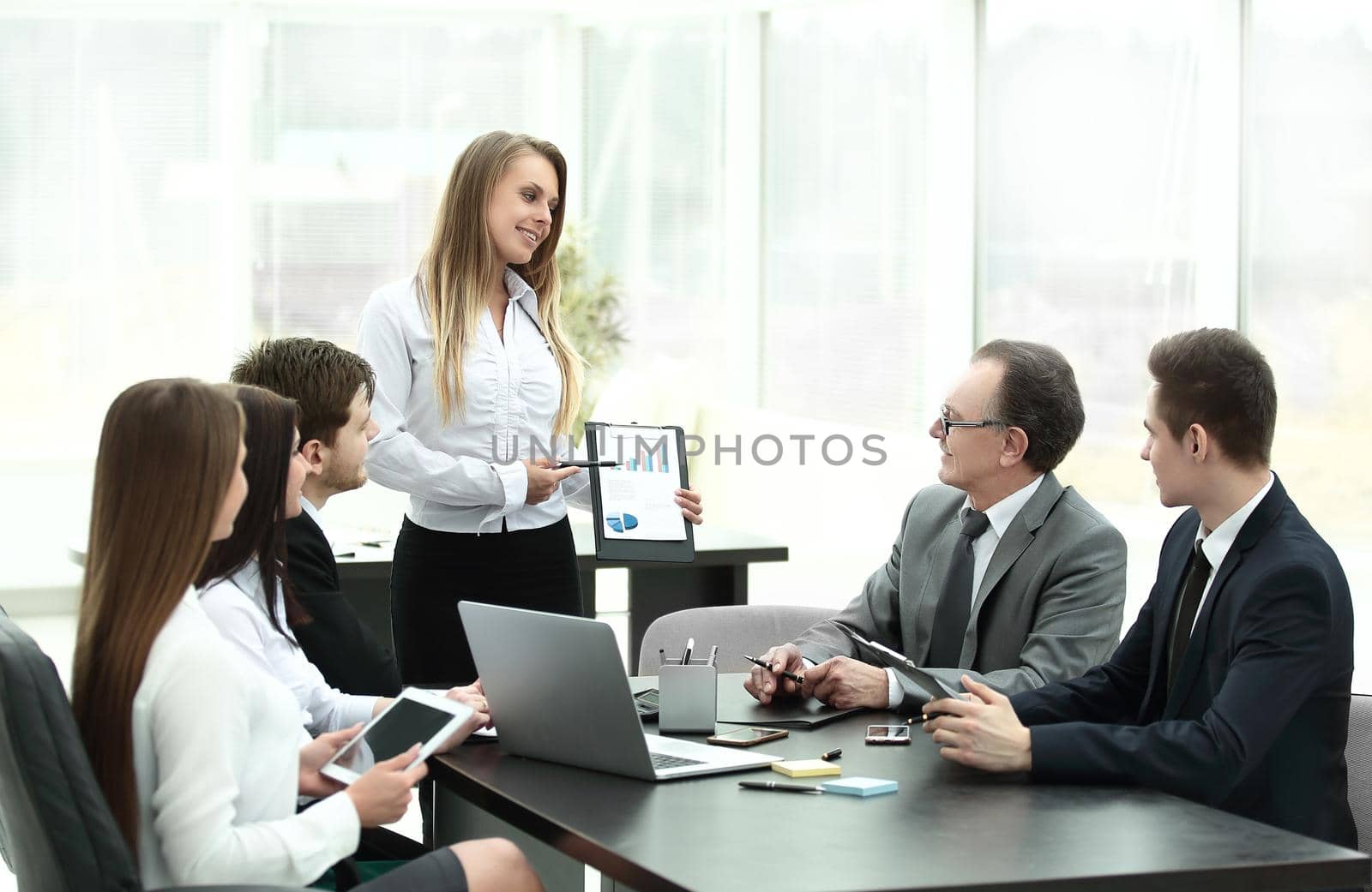 Businesswoman explaining business plan to her colleagues.photo with place for text