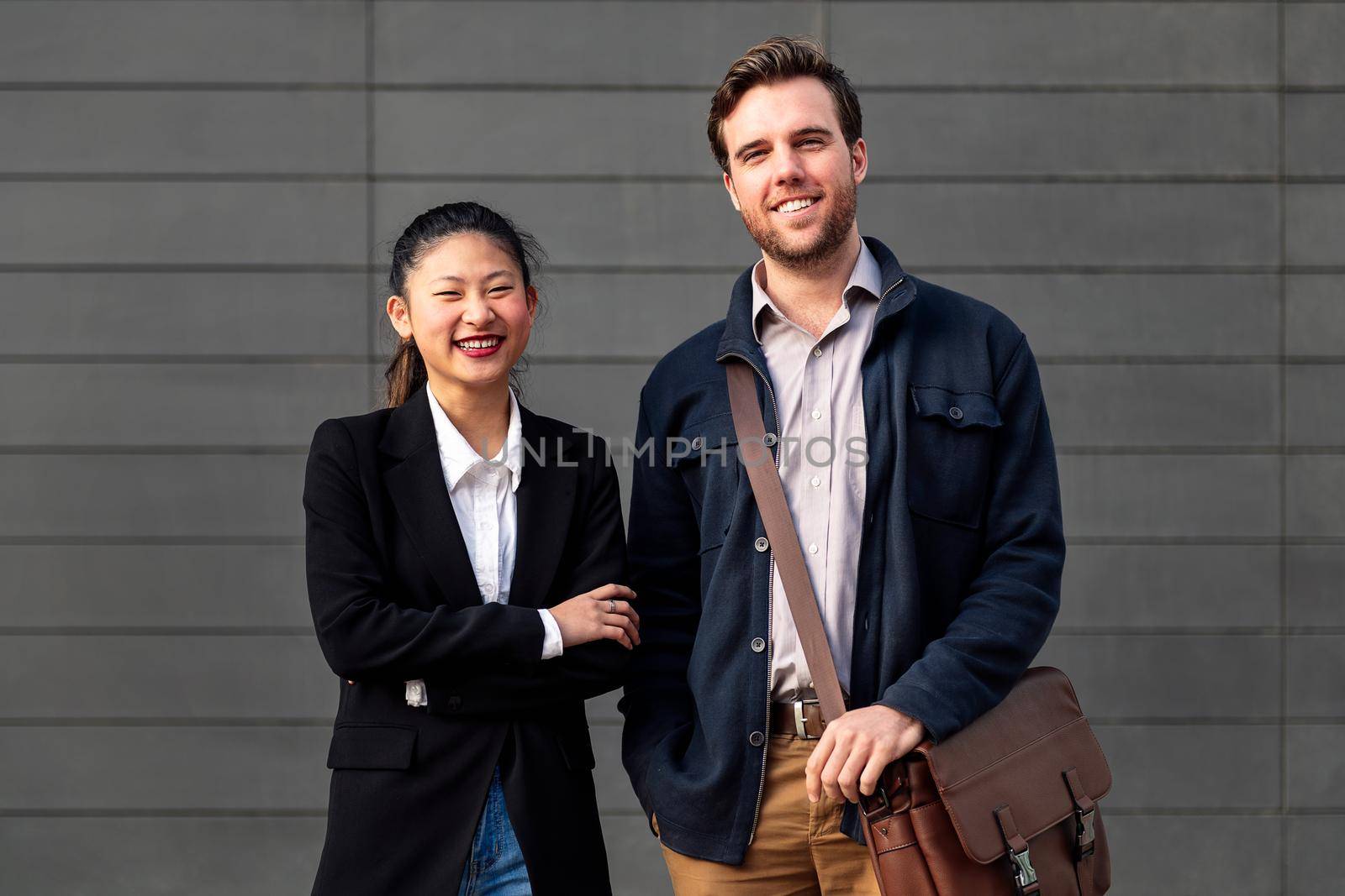 smiling entrepreneur young couple looking at camera, concept of entrepreneurship and business, copy space for text