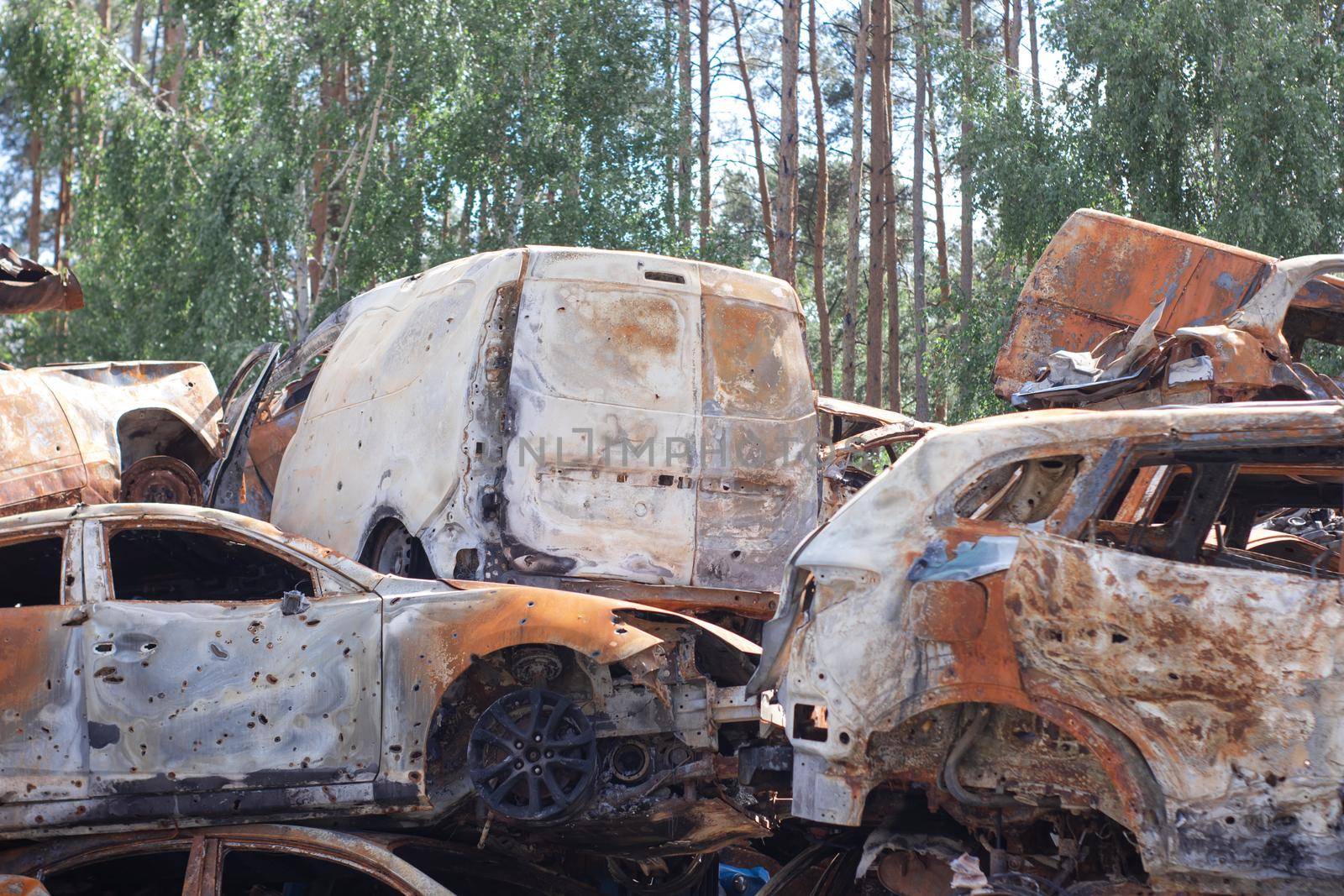 car graveyard. Burnt and blown up car. Cars damaged after shelling from russian invasion. War between Russia and Ukraine. Terror attack bomb shell. Disaster area irpin bucha by oliavesna