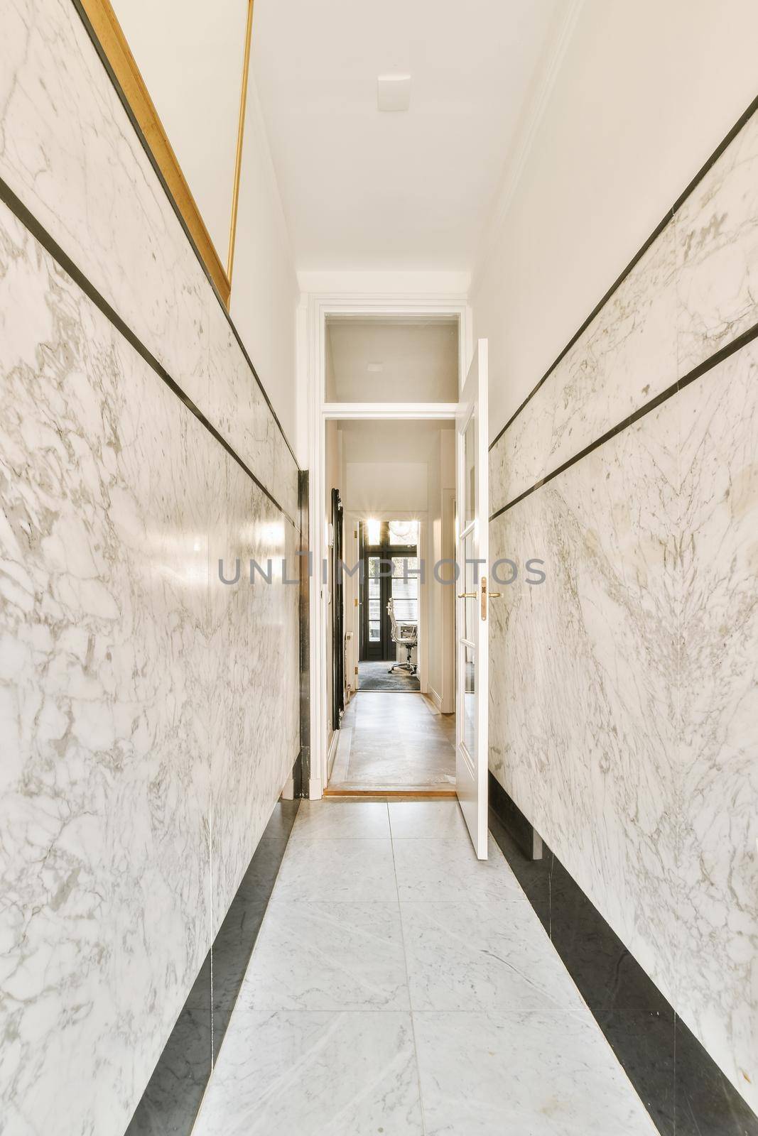 Light narrow hallway with many doors in white walls and glowing lamp over lumber floor