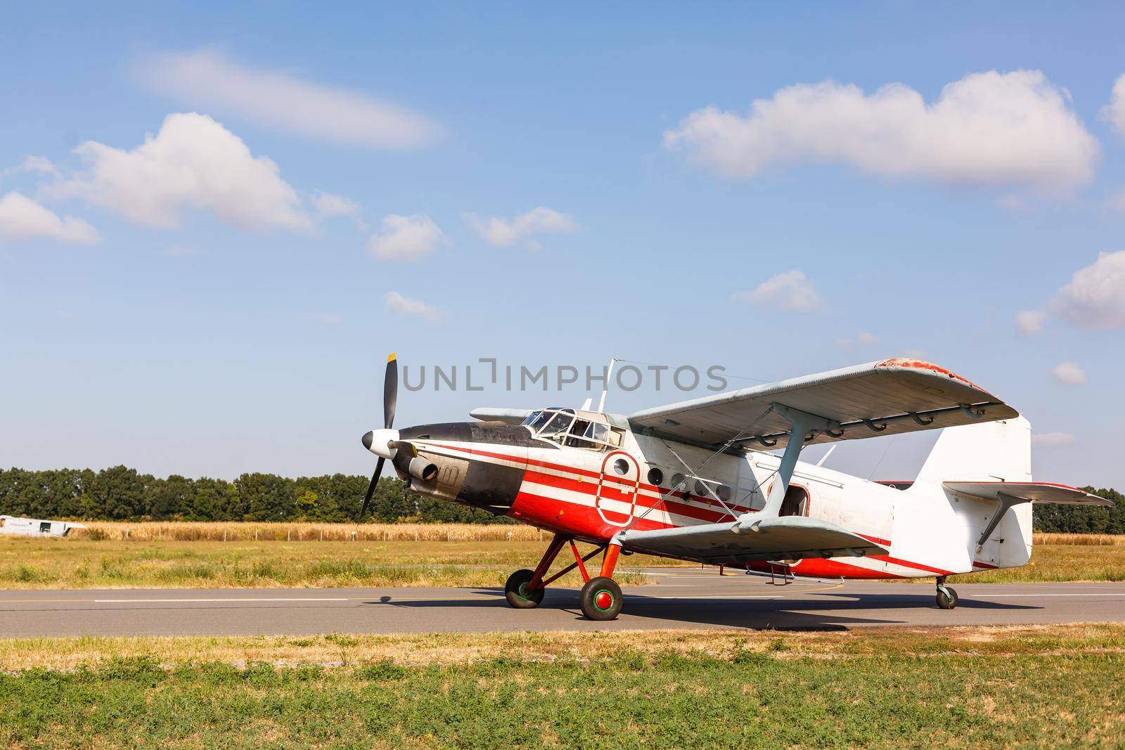 Small aircraft with propeller in parking lot. by Andelov13