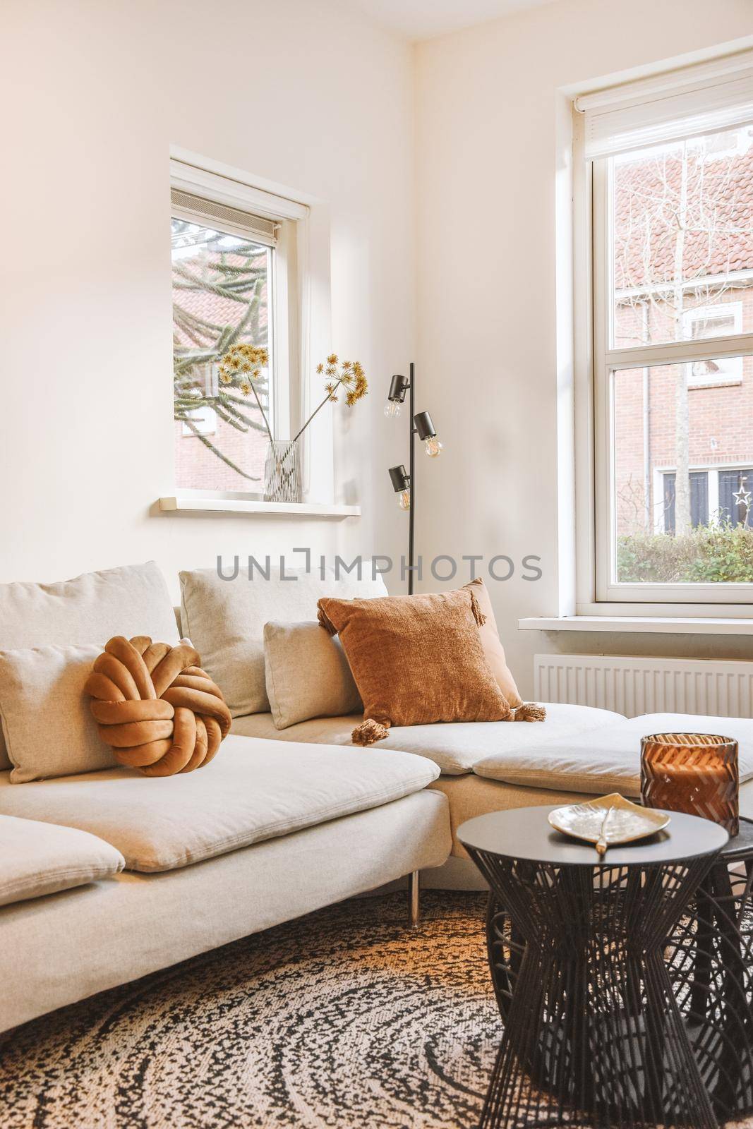 Stylish living-room with white sofa,white and brown pillows and decors