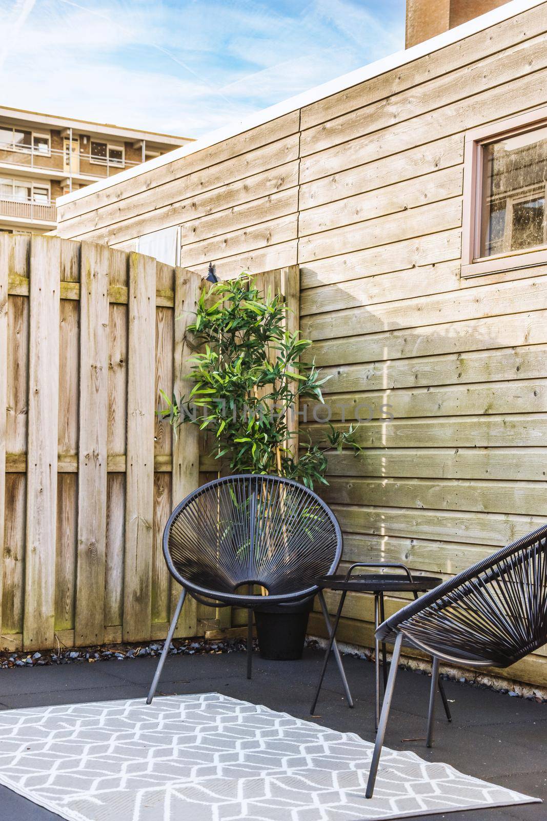 A set of stylish chairs and round table in the terrace of the house