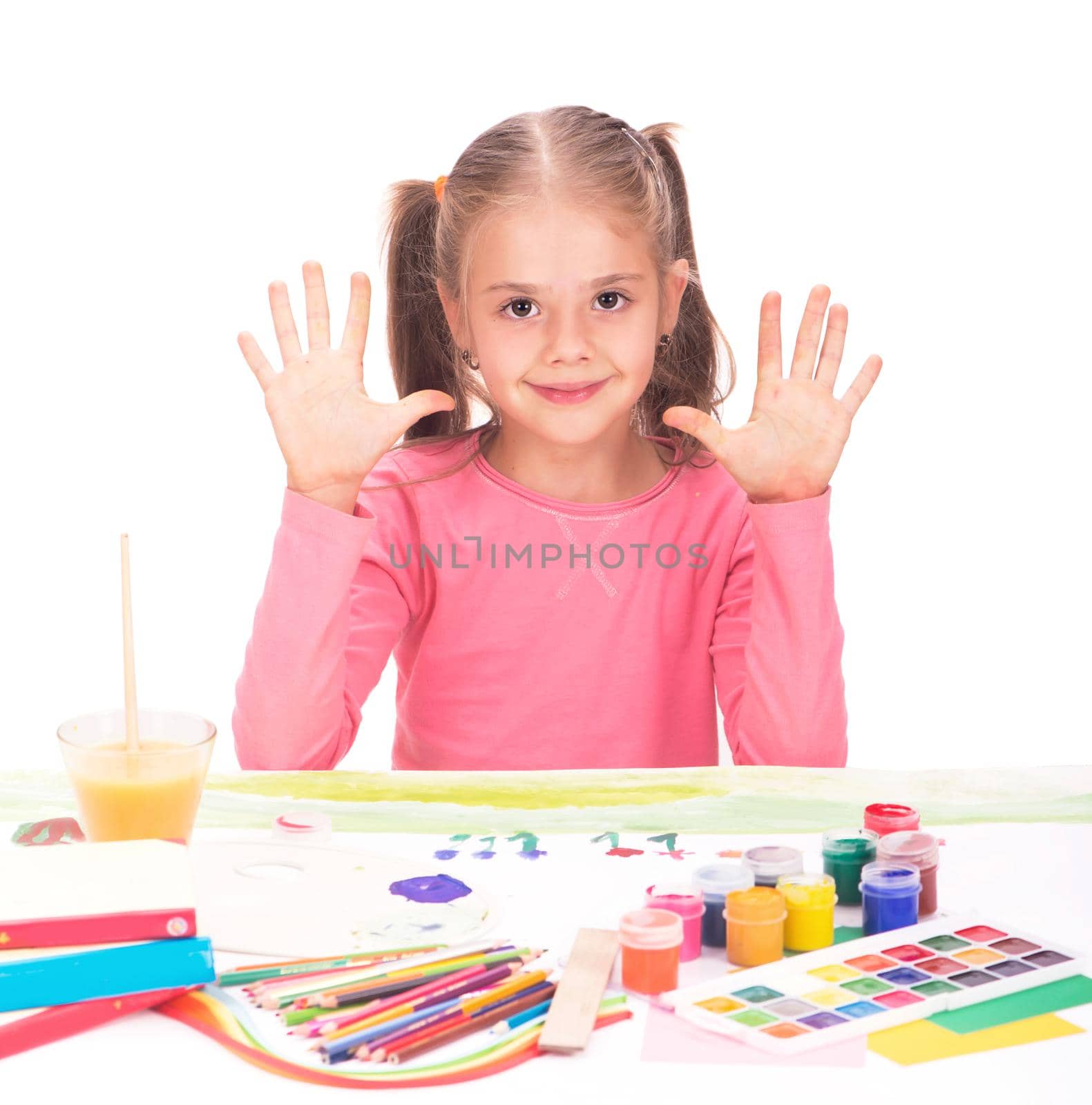 The child, a little girl draws paints