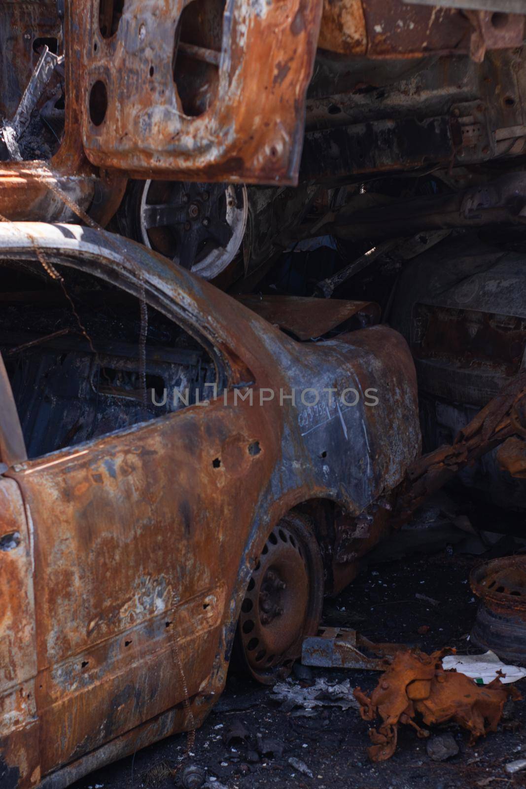 car graveyard. Burnt and blown up car. Cars damaged after shelling from russian invasion. War between Russia and Ukraine. Terror attack bomb shell. Disaster area irpin bucha by oliavesna