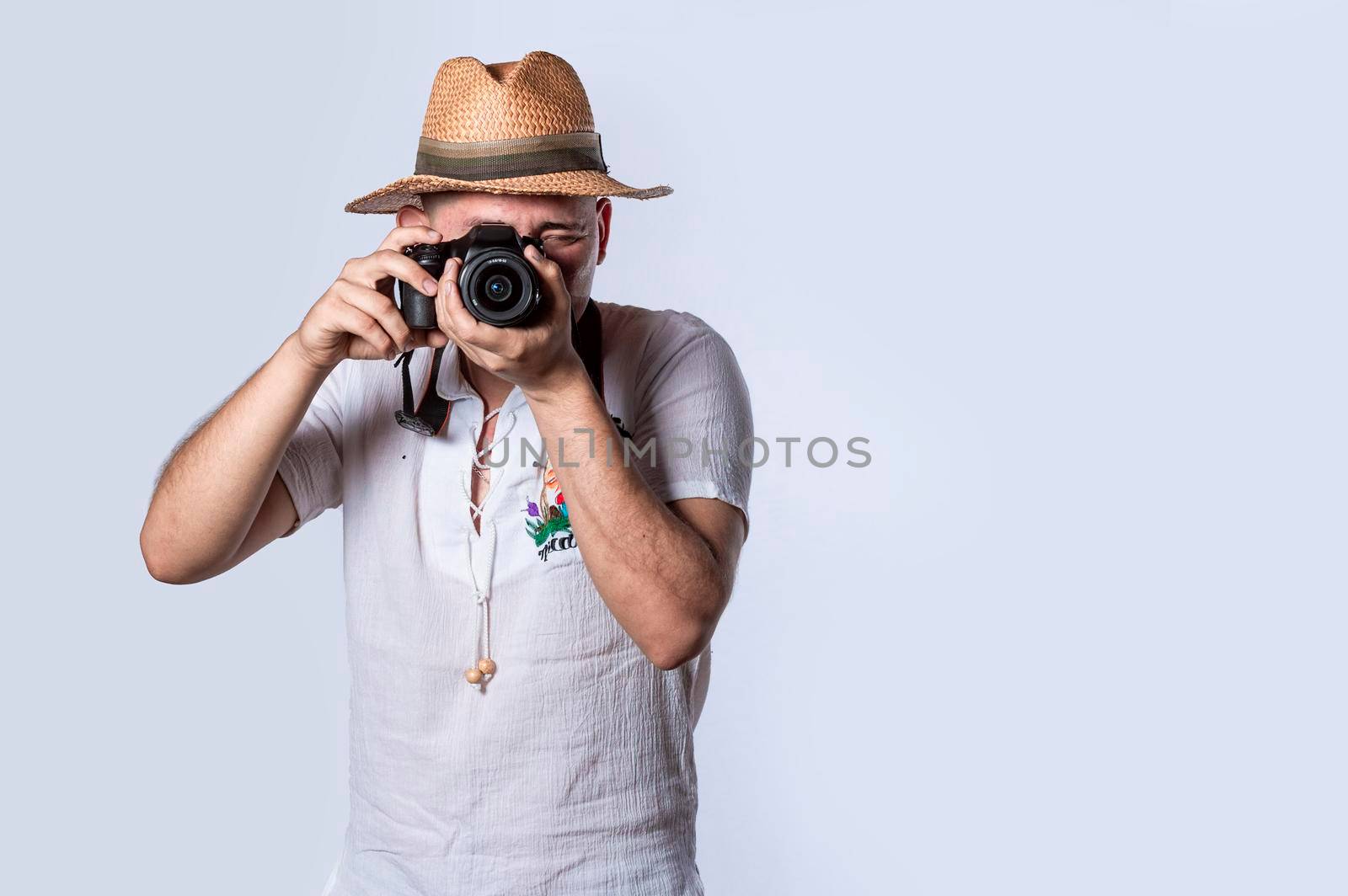 tourist in a hat with a camera, Happy tourist in a hat with a camera around his neck by isaiphoto