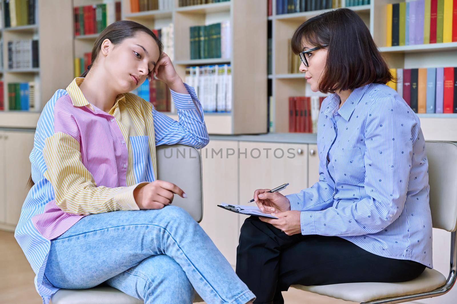 Psychologist, teacher, behavior, high school counselor counseling teenage student in library, office. Psychological help, social work, mental health, adolescence, youth psychotherapy psychology concept