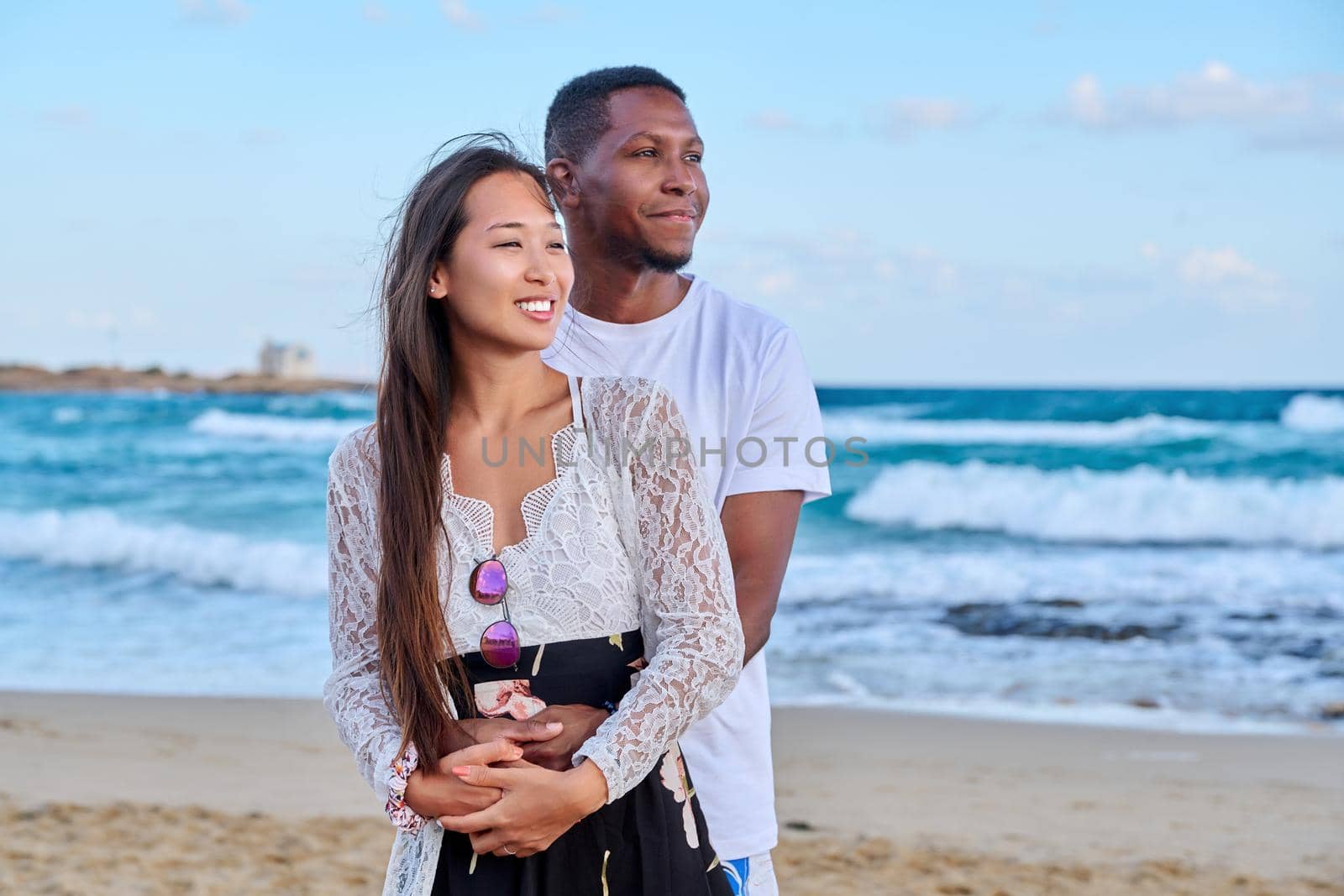 Beautiful young couple in love on the beach by VH-studio