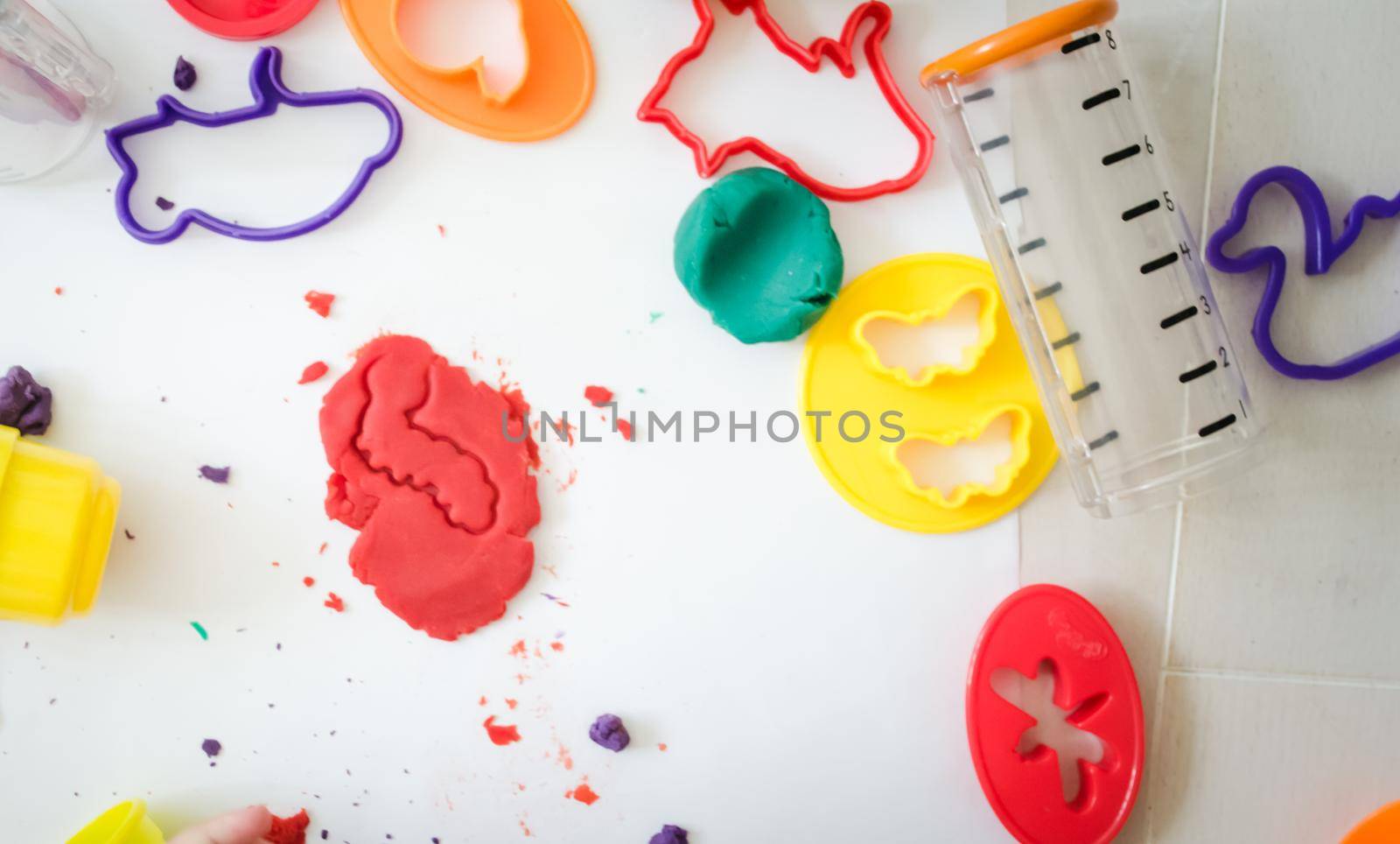 kid is playing with colourful plasticine in kindergarten. High quality photo