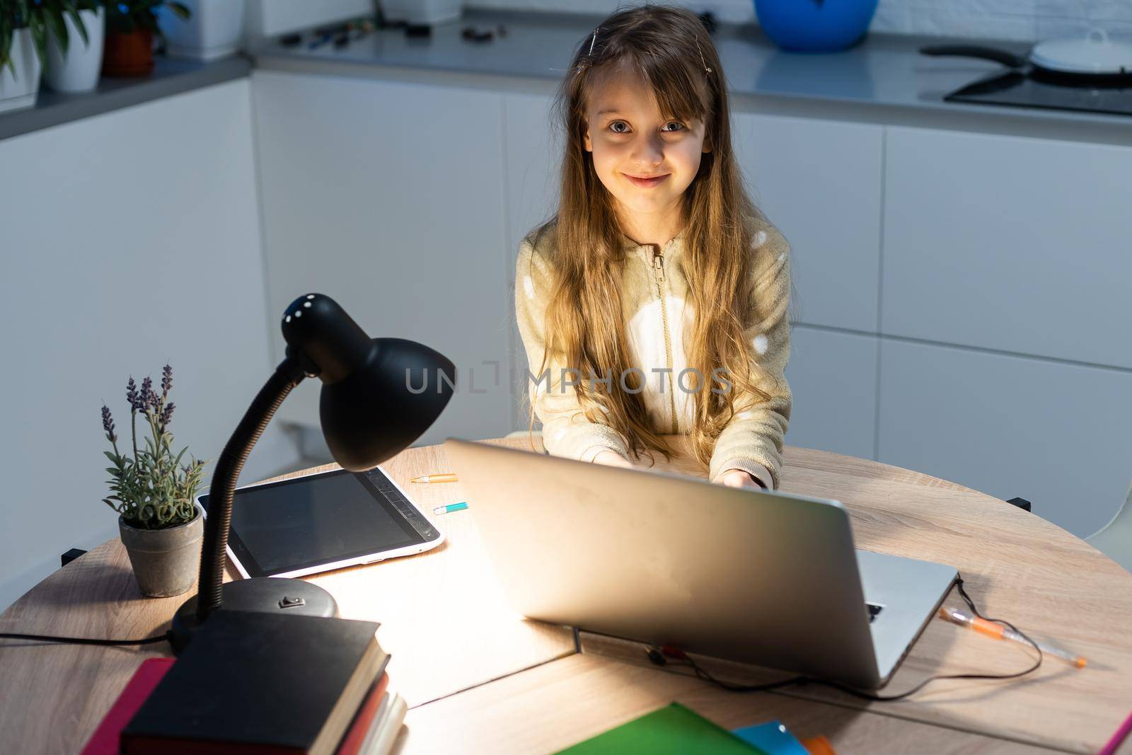 Online education of children. Girl schoolgirl has a lesson online using a laptop video chat call conference with a teacher at home