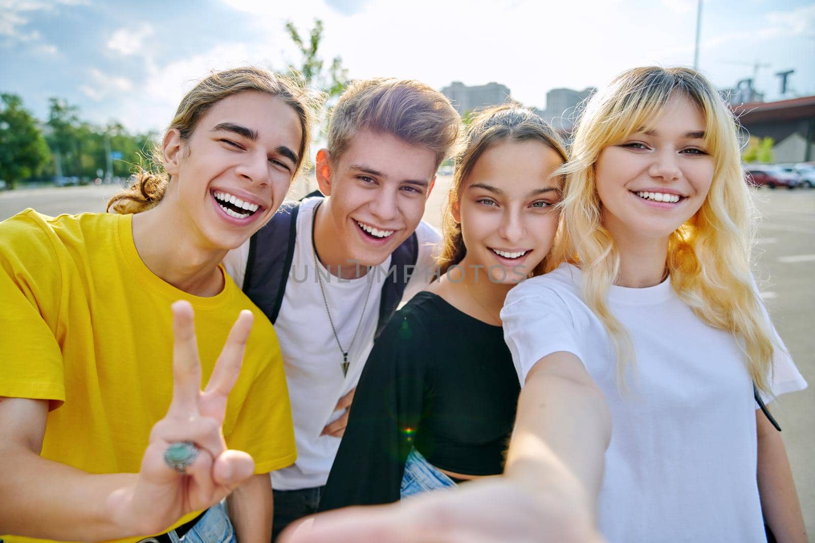 Group of happy teenage friends taking selfie photo by VH-studio