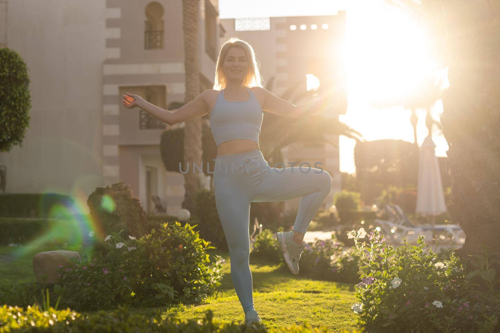 woman doing yoga outdoors in the hotel.