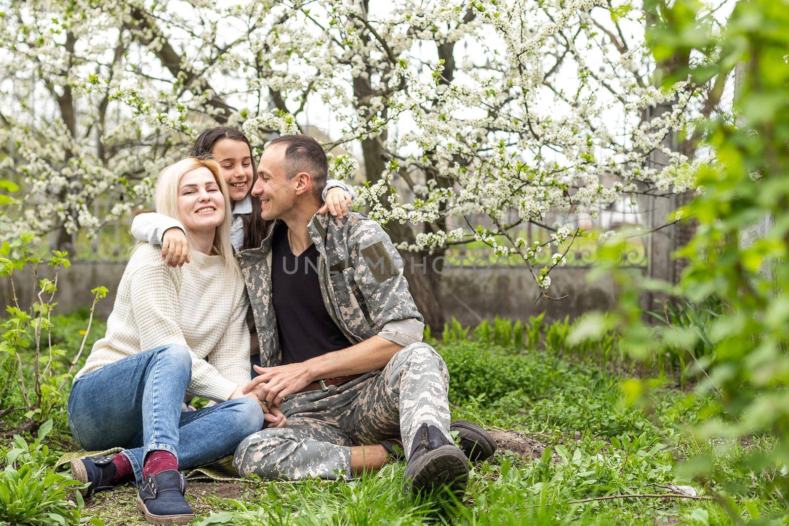 Happy soldier with family in park. by Andelov13