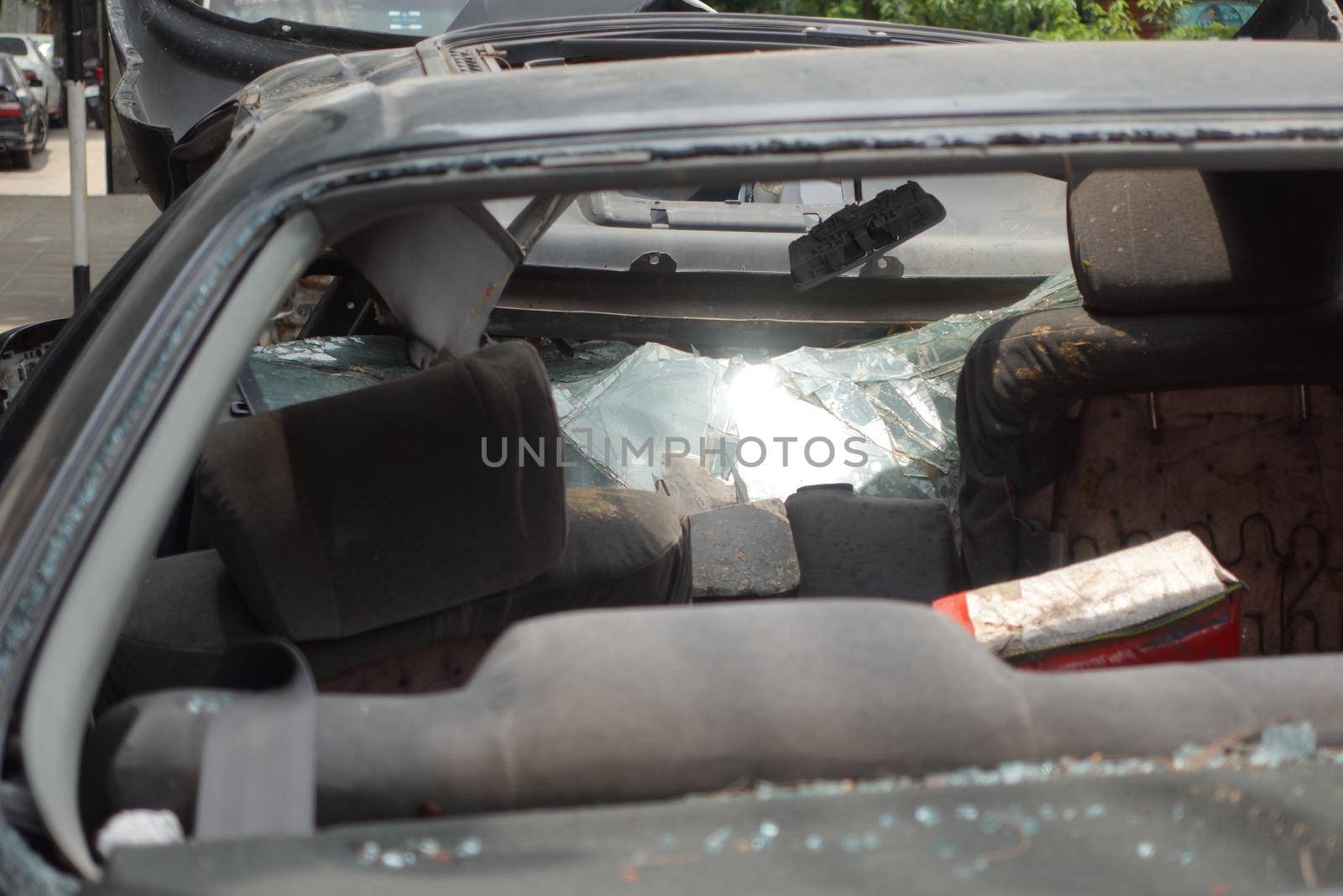 black car damaged by a road accident .