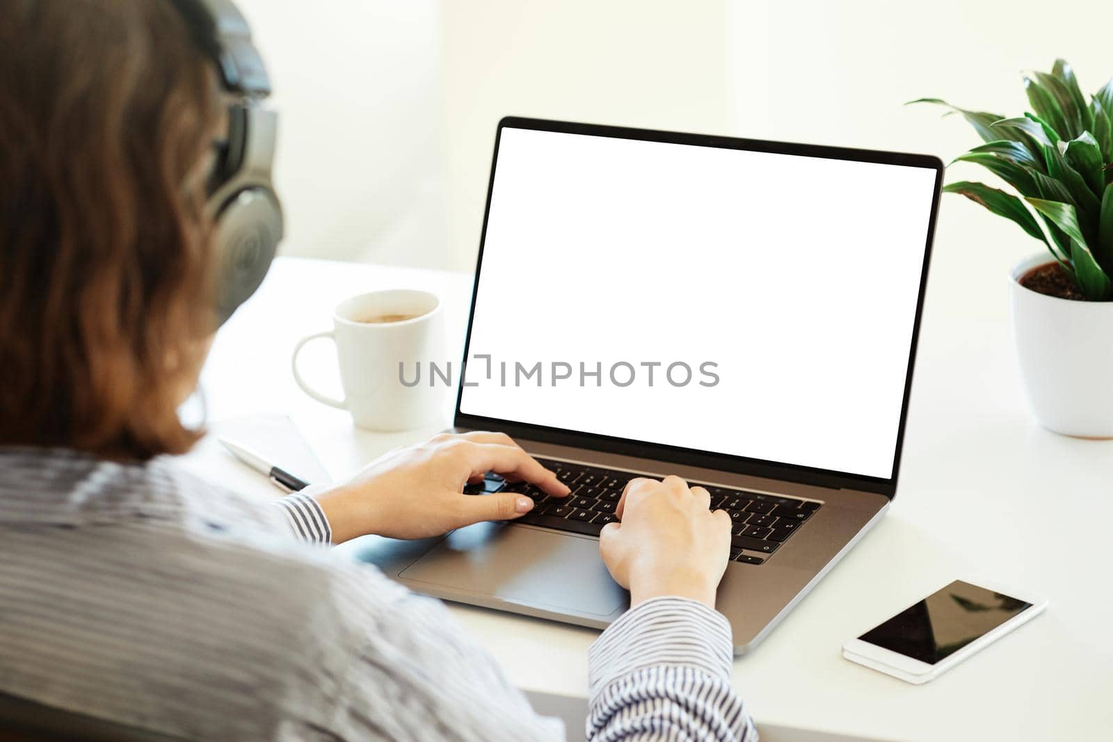 Close up of woman's hands typing on a laptop in an office or at home