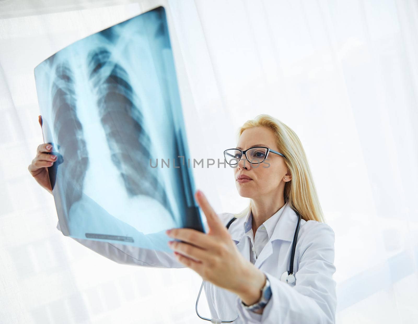 Doctors looking at a x-ray image in their hospital office