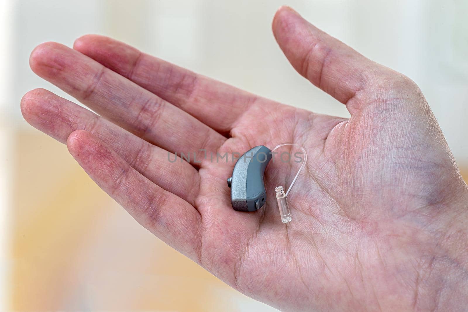 Hearing aid in close-up in the palm of your hand